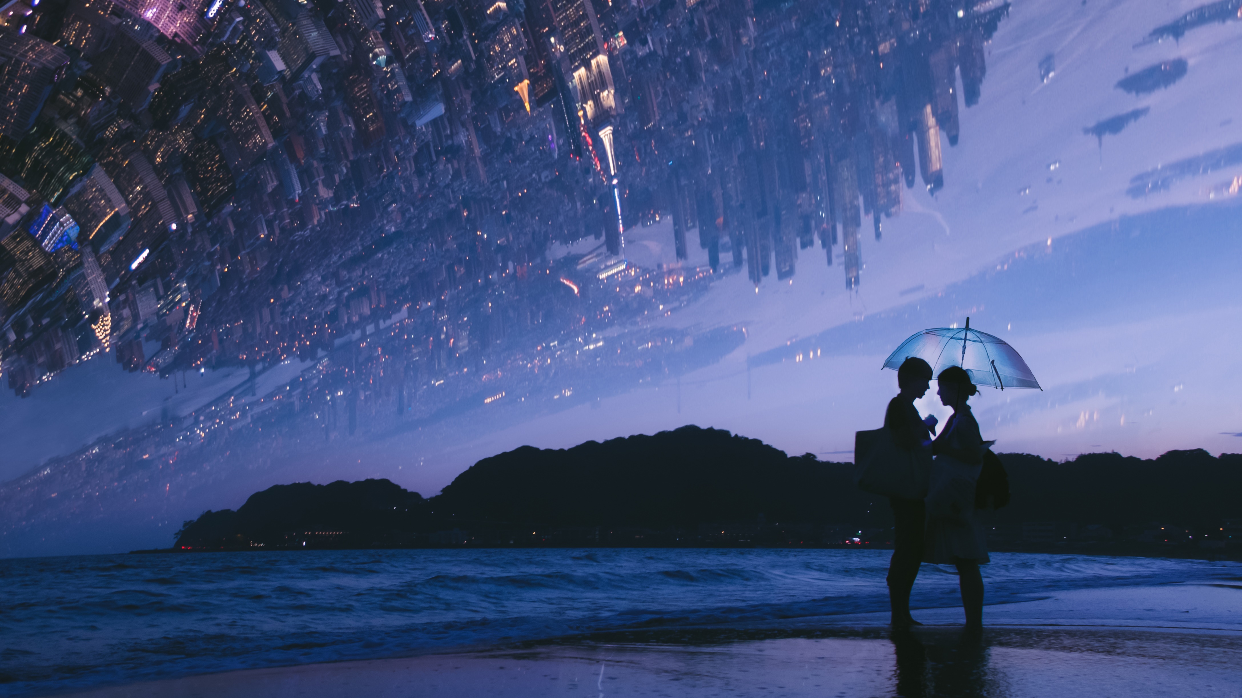 Couple under umbrella on beach with inverted cityscape HD Wallpaper