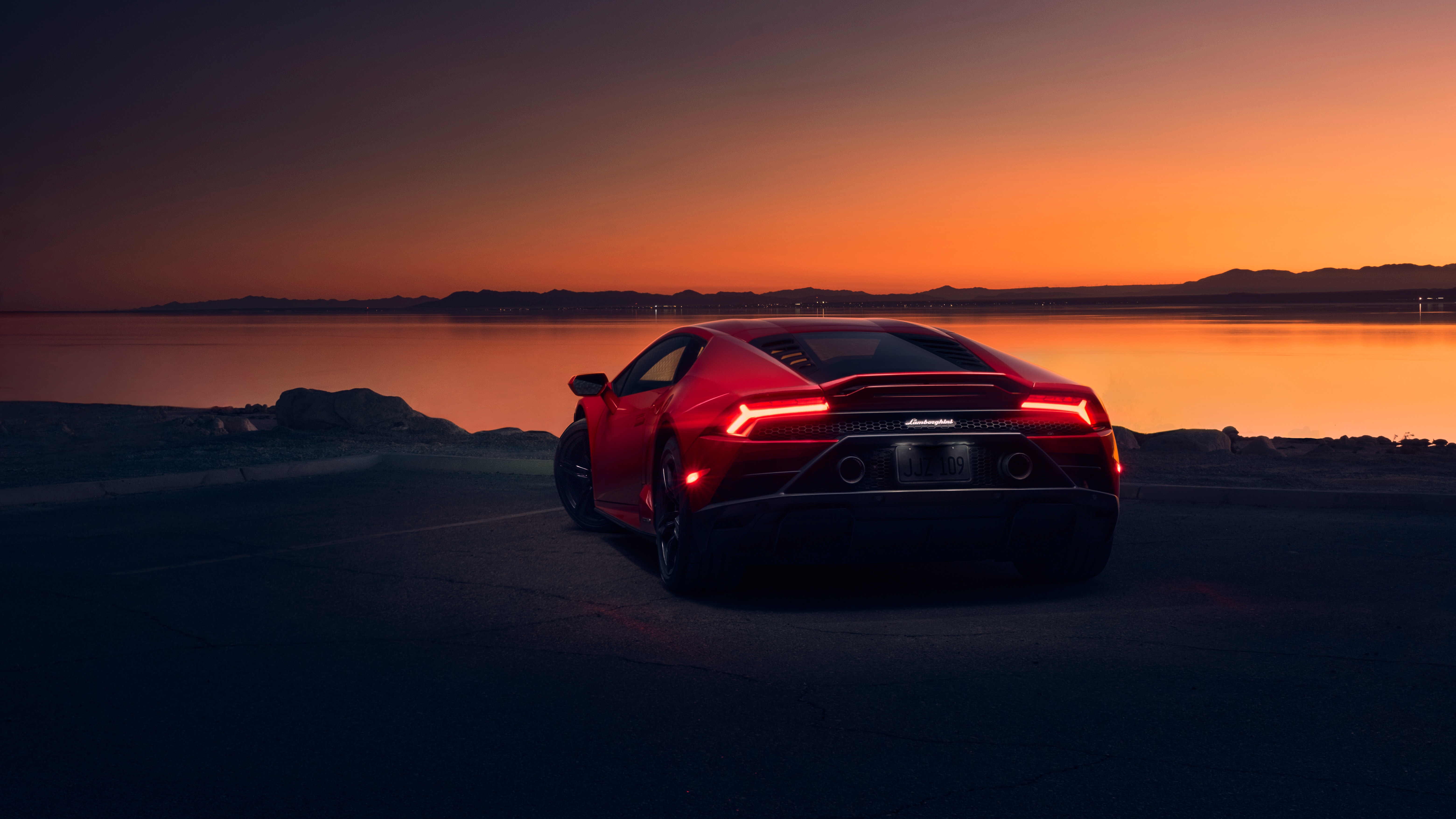 Red Lamborghini Huracan at sunset by the water HD Wallpaper