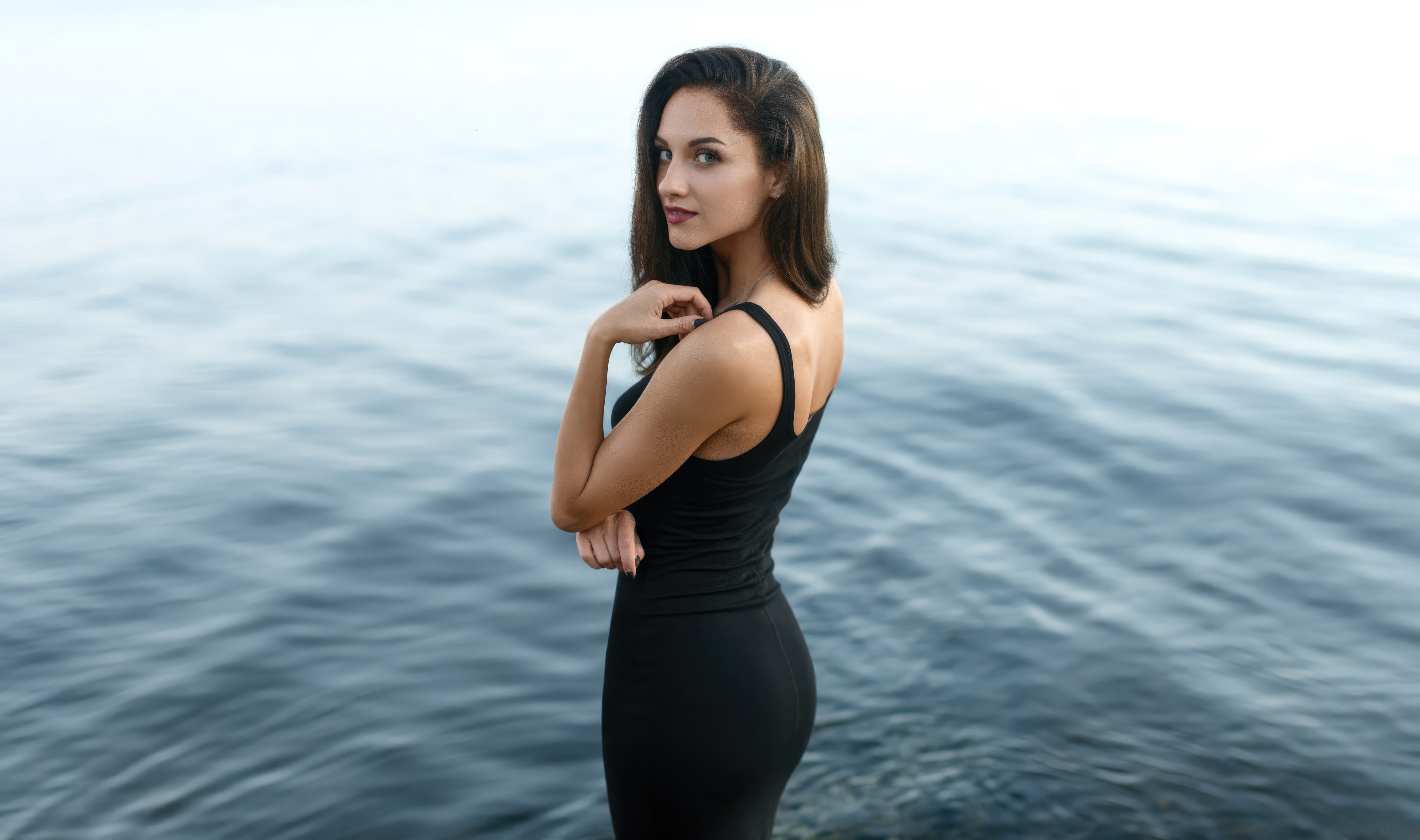 Woman in black dress by the water 4K HD Wallpaper