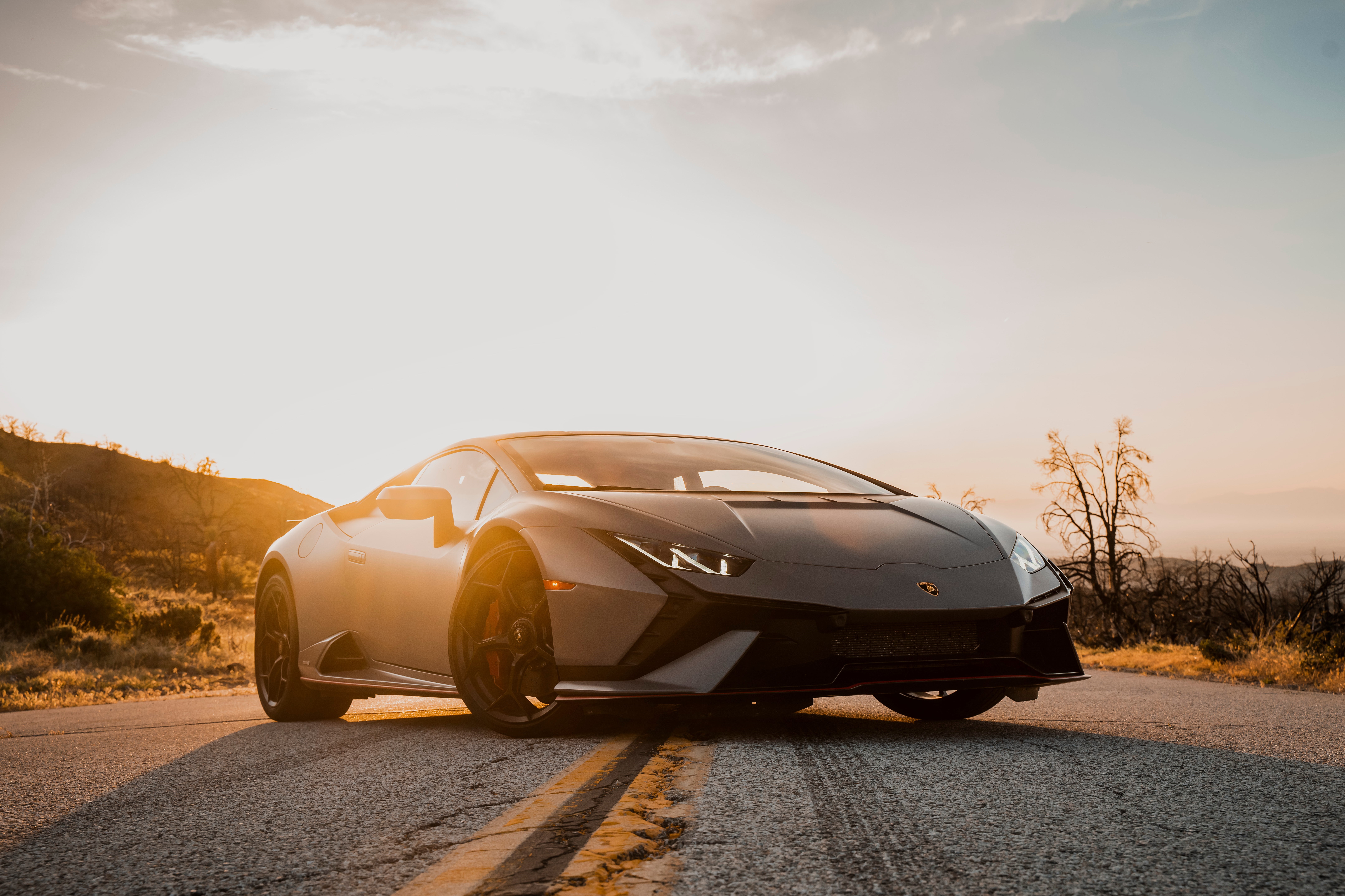 Lamborghini Huracan on a road at sunset HD Wallpaper