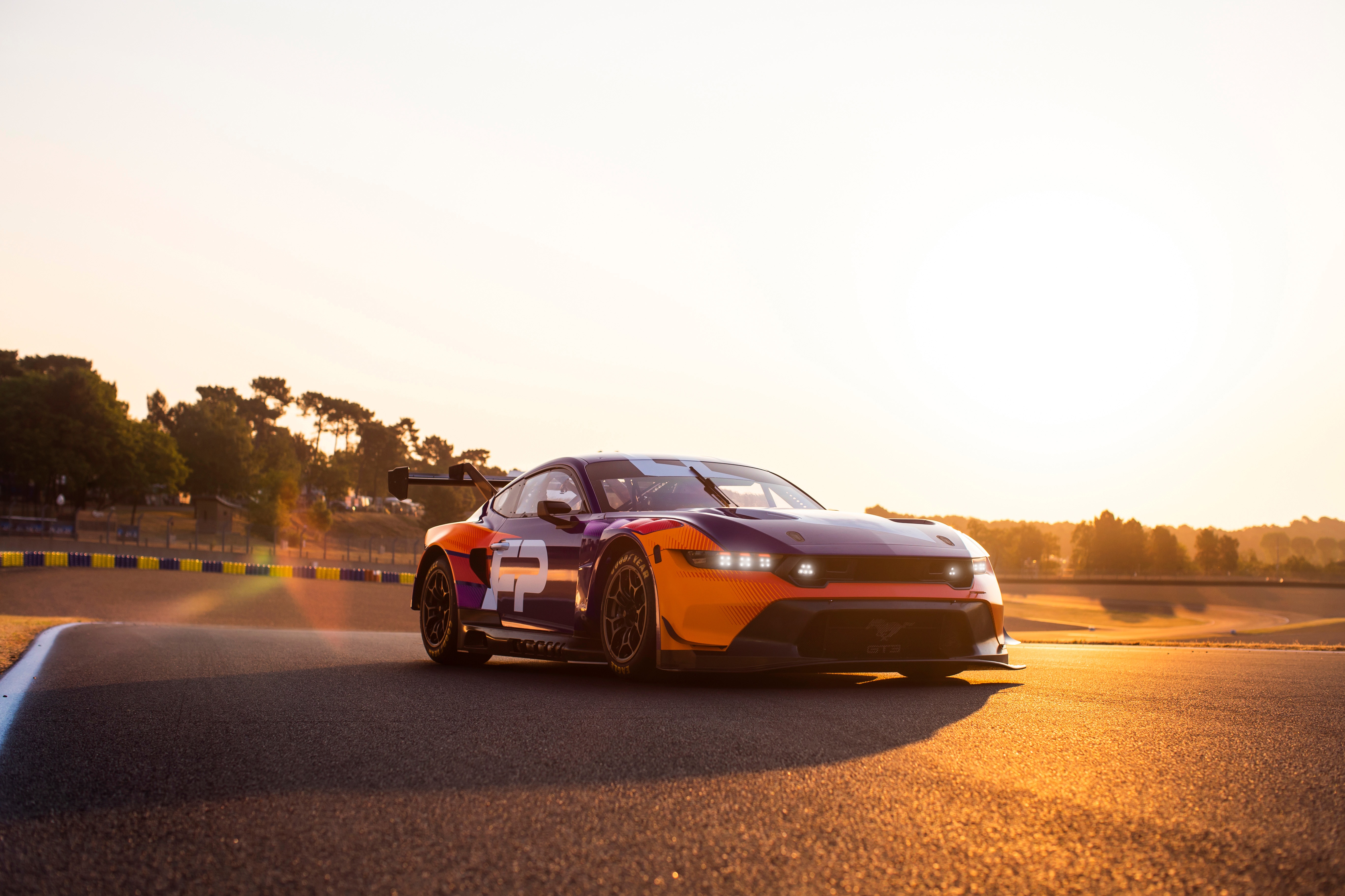 Ford Mustang GT3 race car on a track at sunset HD Wallpaper