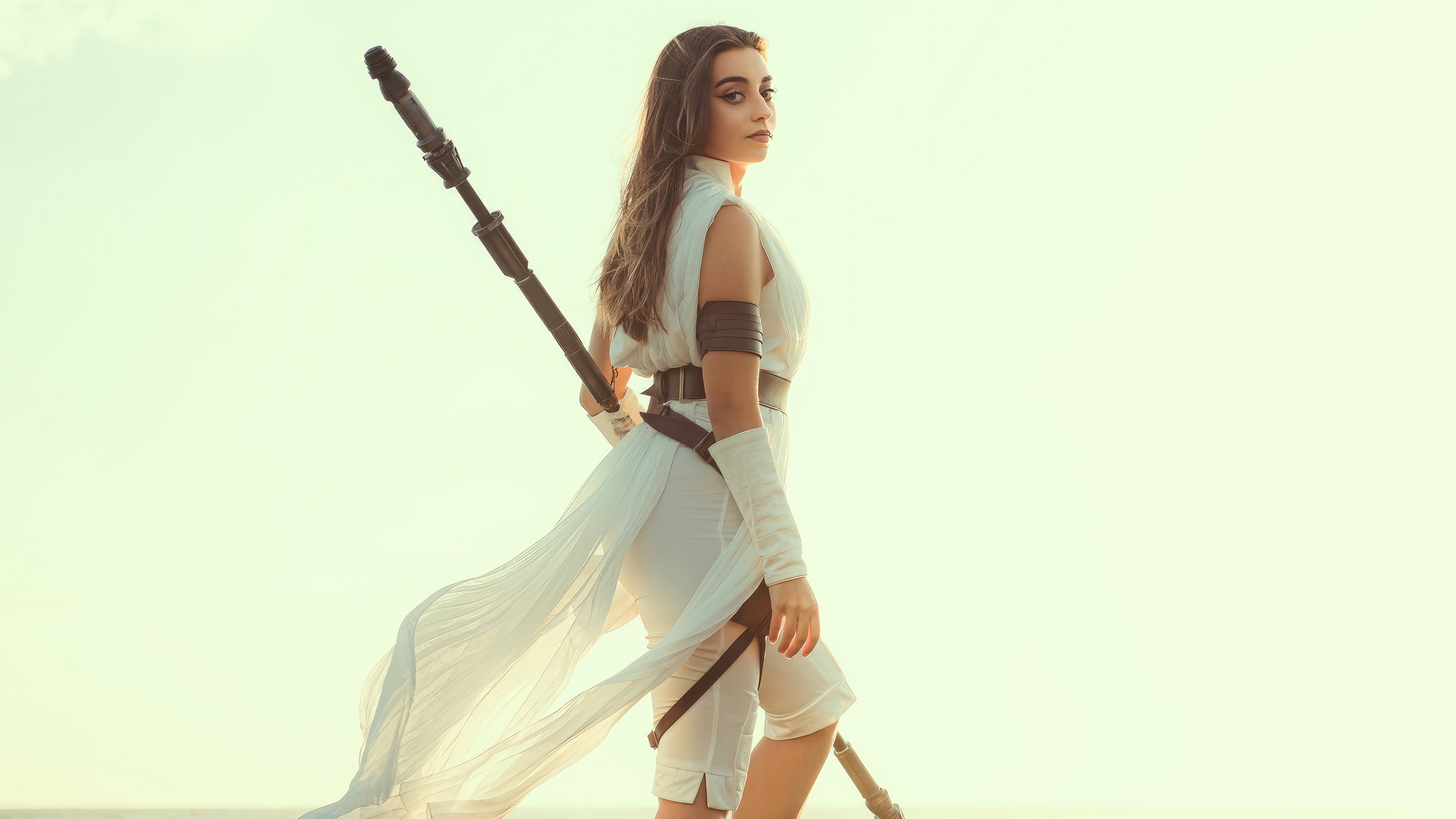 Rey from Star Wars holding a staff HD Wallpaper