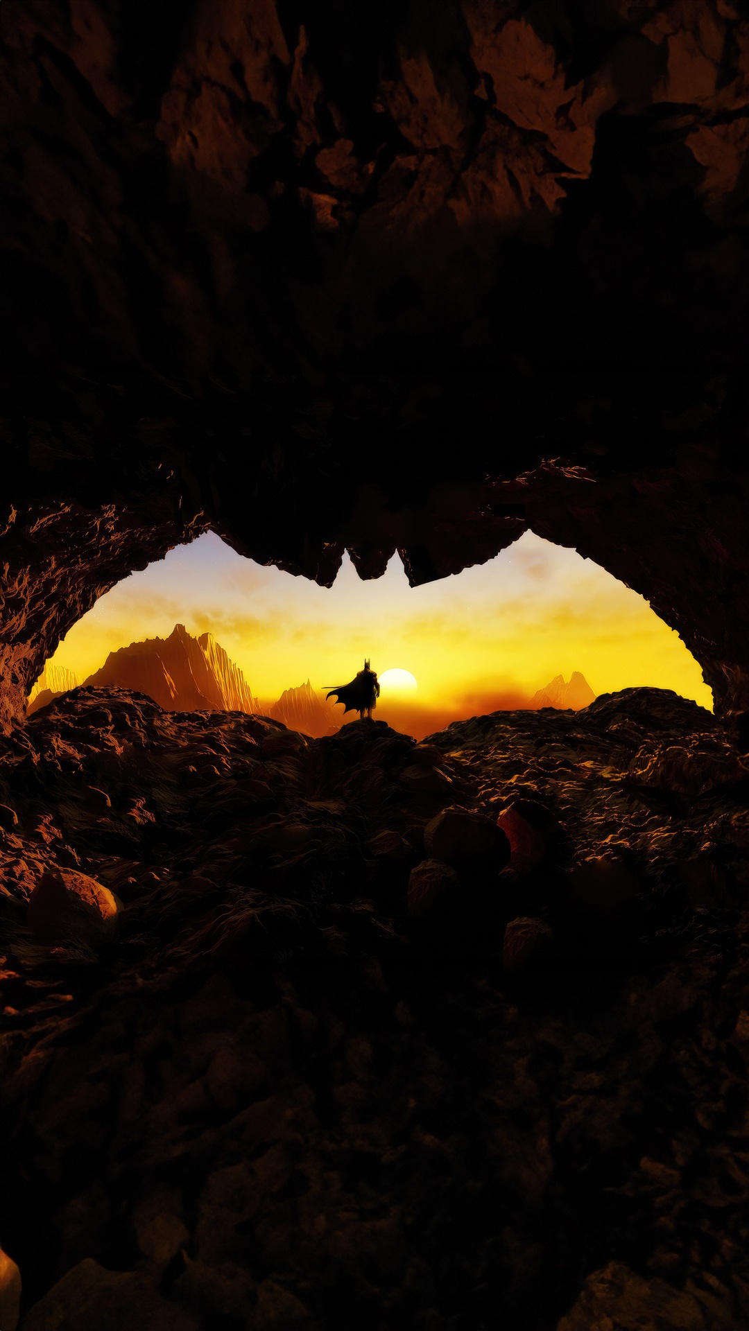 Batman standing in a cave entrance at sunset HD Phone Wallpaper