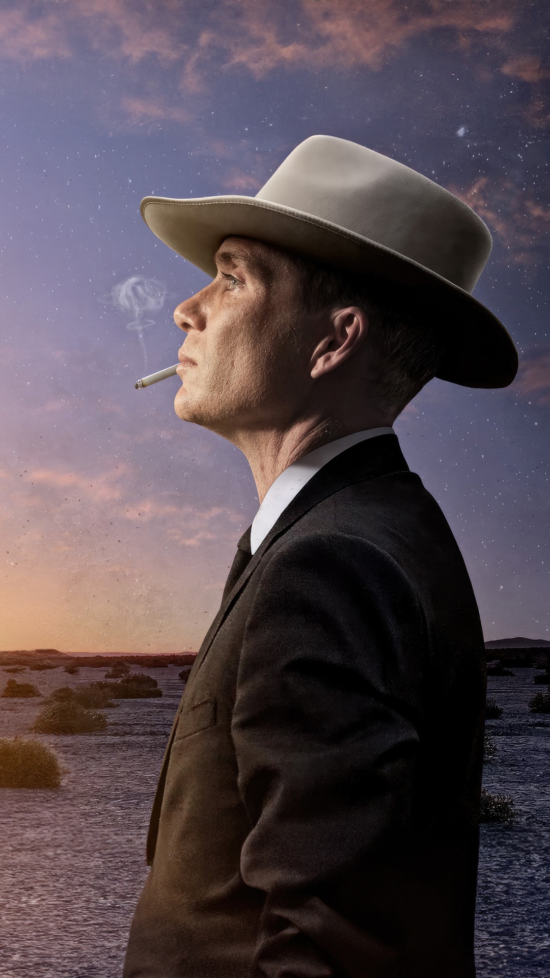Oppenheimer smoking in a desert landscape HD Phone Wallpaper