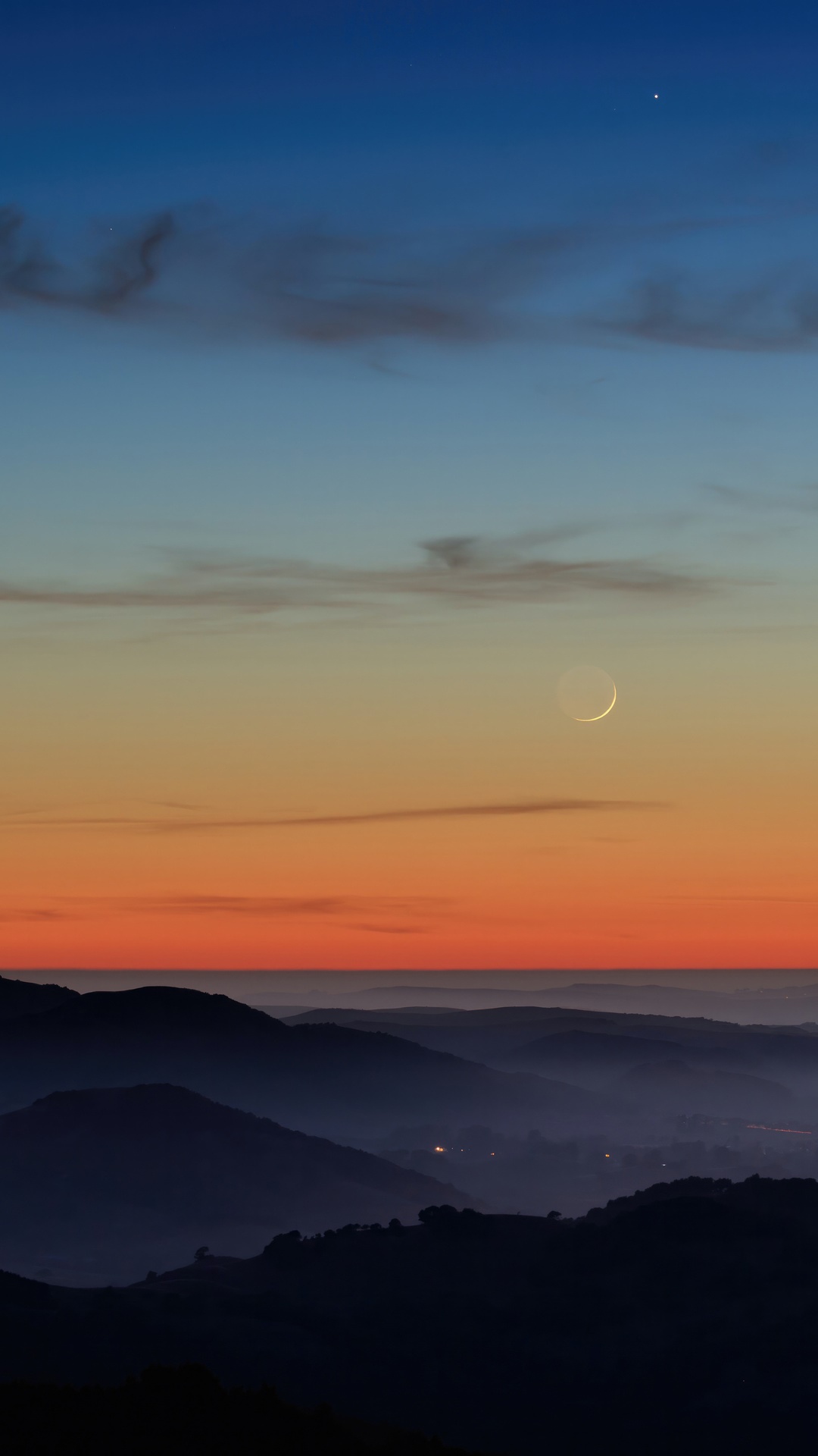 Crescent moon over misty mountains at sunset HD Phone Wallpaper