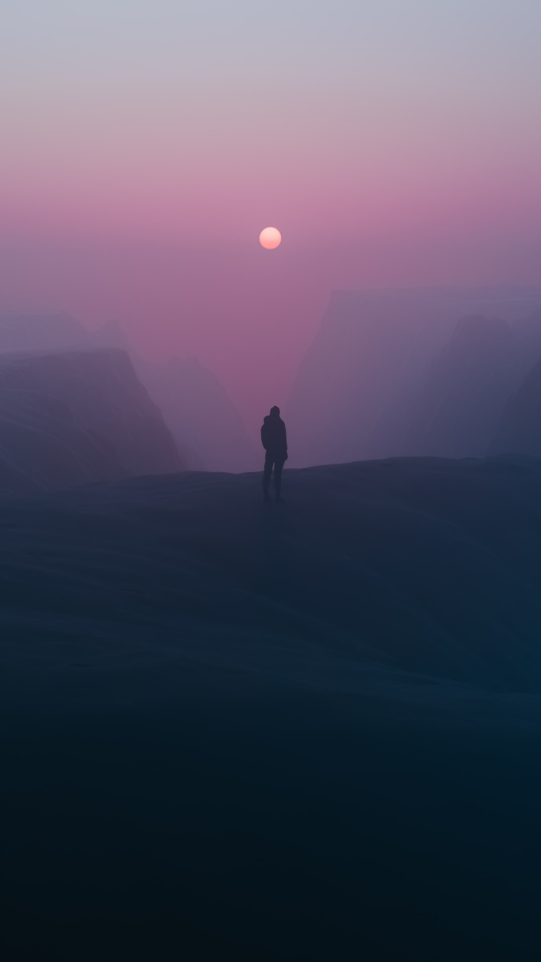 Lone figure stands on a misty mountain at sunset HD Phone Wallpaper