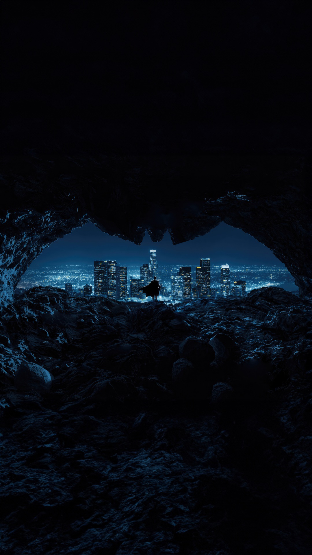 Batman overlooking a city from a cave 4K HD Phone Wallpaper