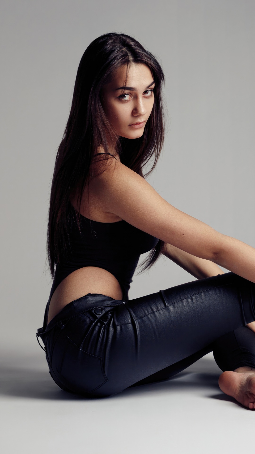 Model in black bodysuit and leather pants HD Phone Wallpaper