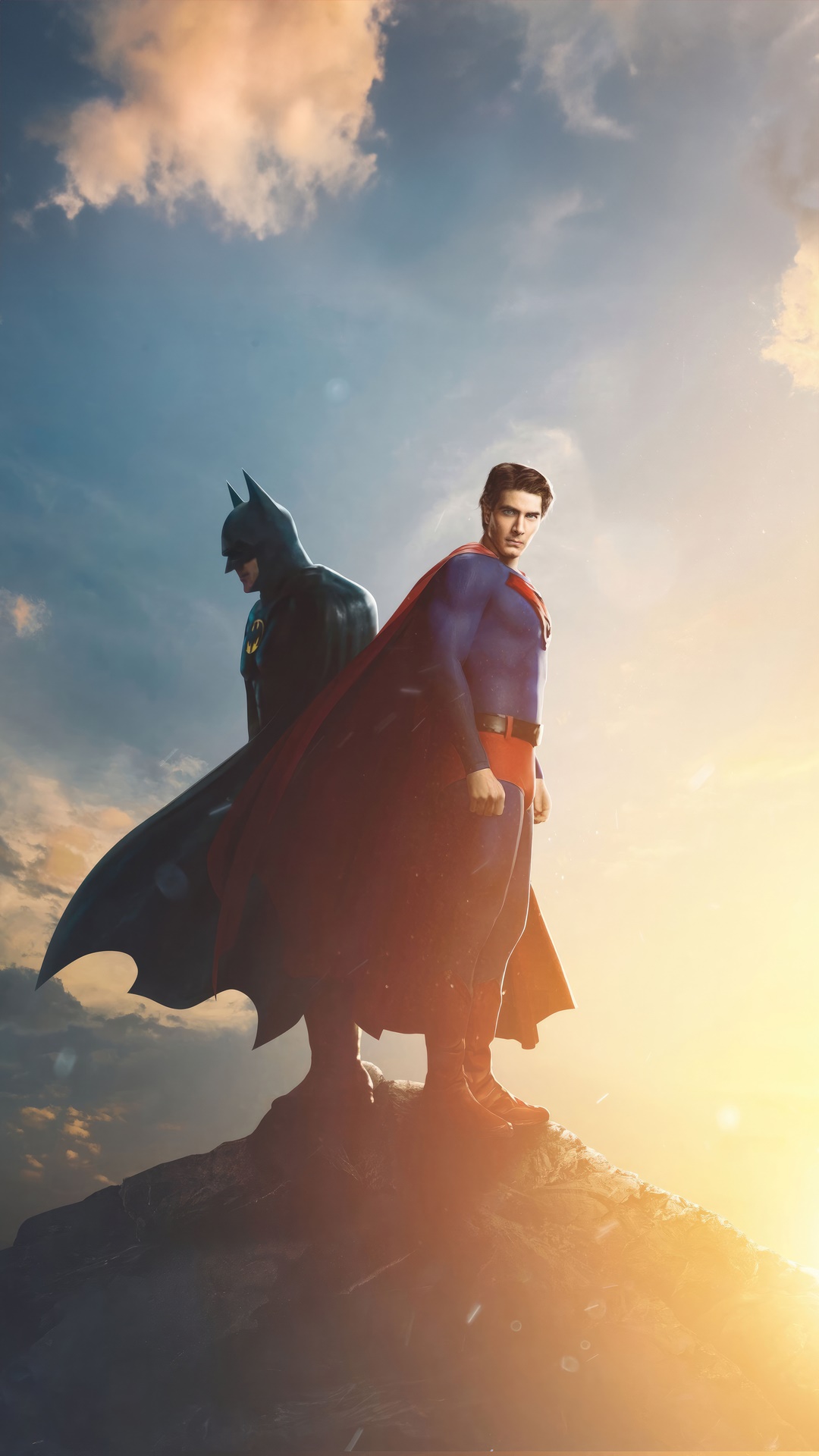 Batman and Superman standing on a rocky outcrop HD Phone Wallpaper
