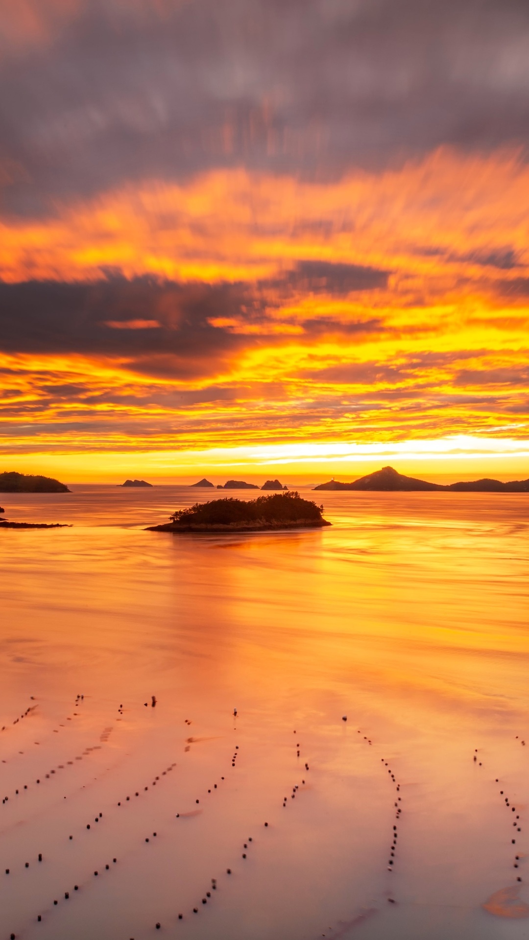 Sunset over islands and calm ocean with reflections HD Phone Wallpaper