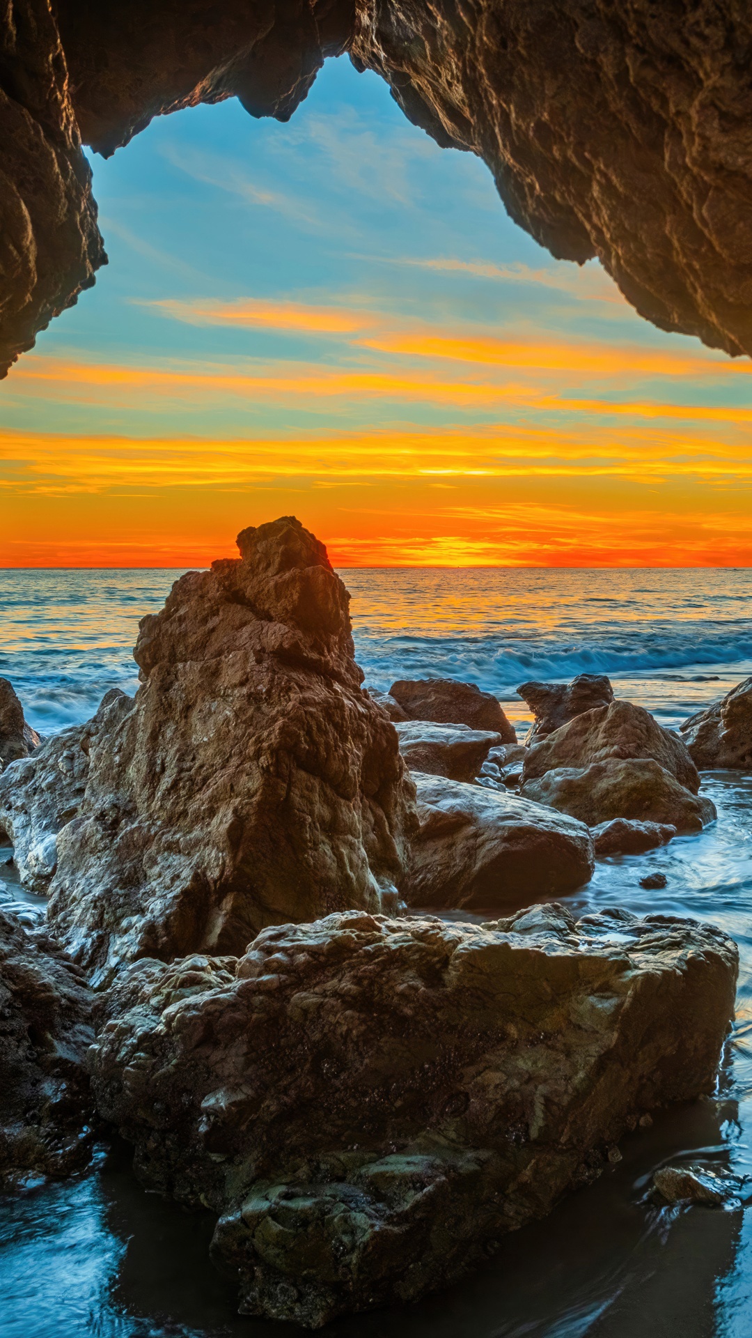 Cave overlooking ocean at sunset HD Phone Wallpaper