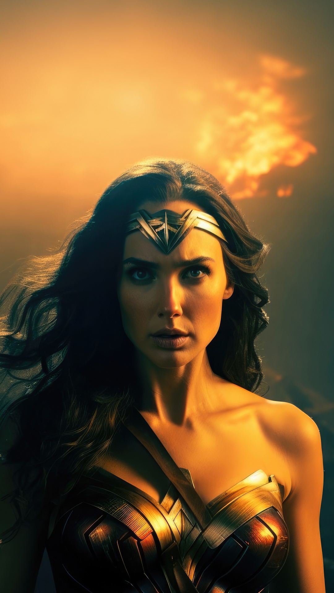 Wonder Woman in a golden costume against a fiery sky HD Phone Wallpaper