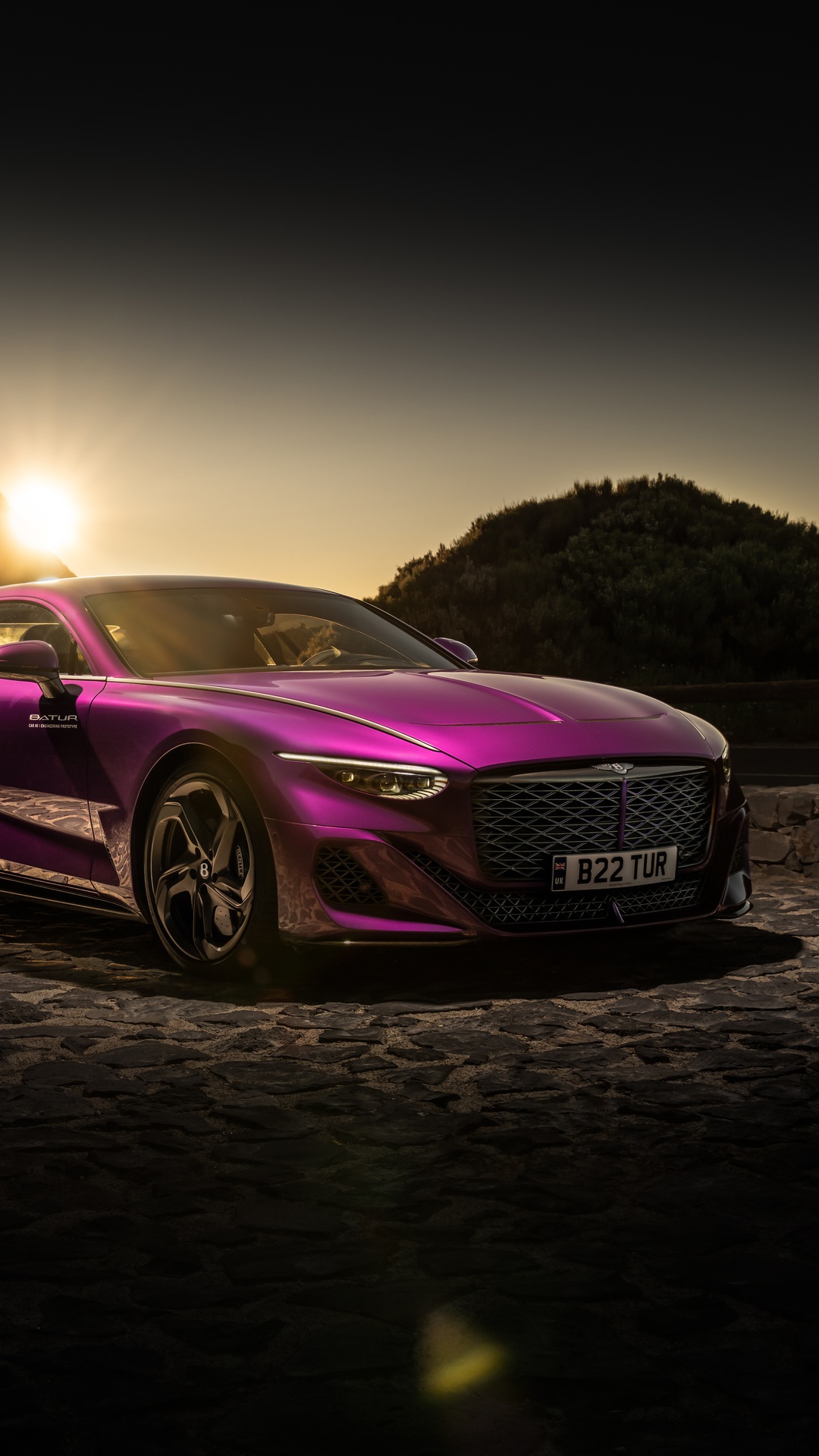 Bentley Batur parked on cobblestone road at sunset HD Phone Wallpaper