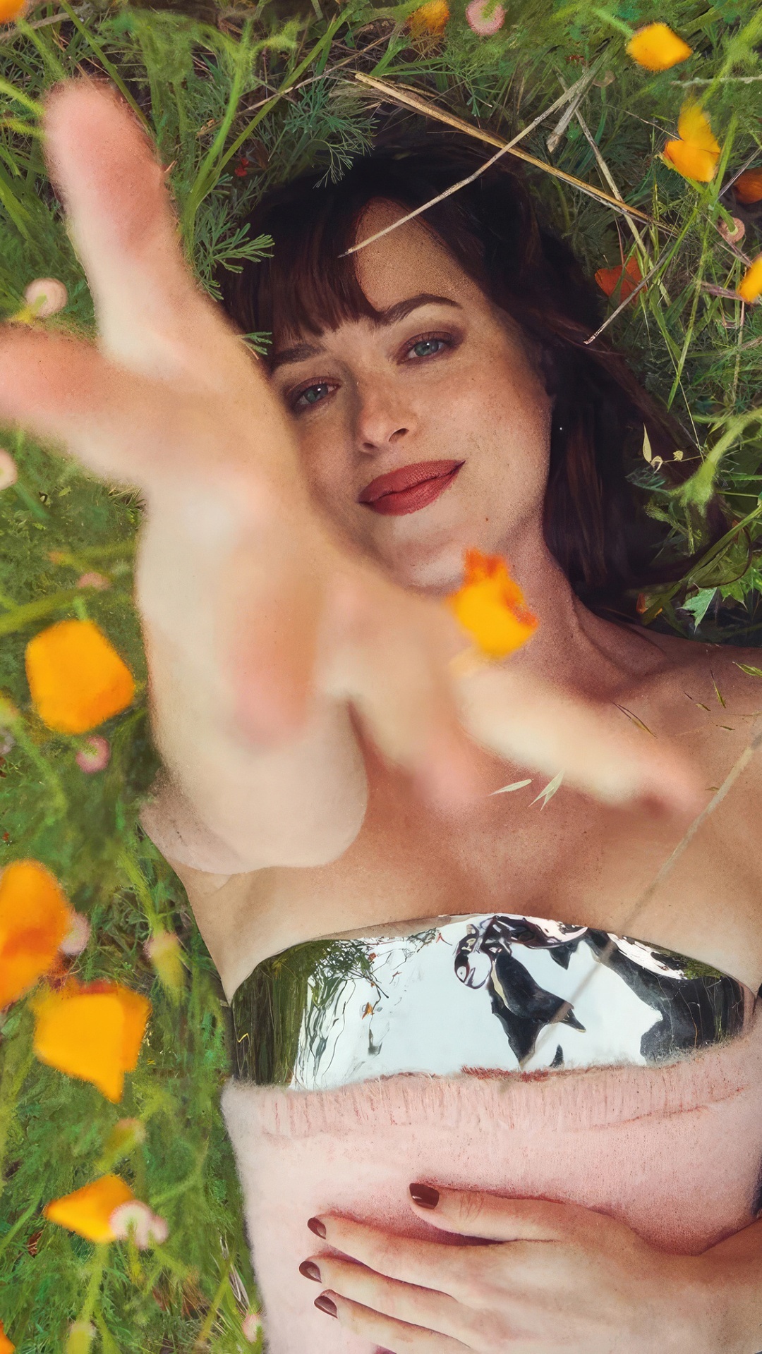 Dakota Johnson lying in a field of flowers HD Phone Wallpaper