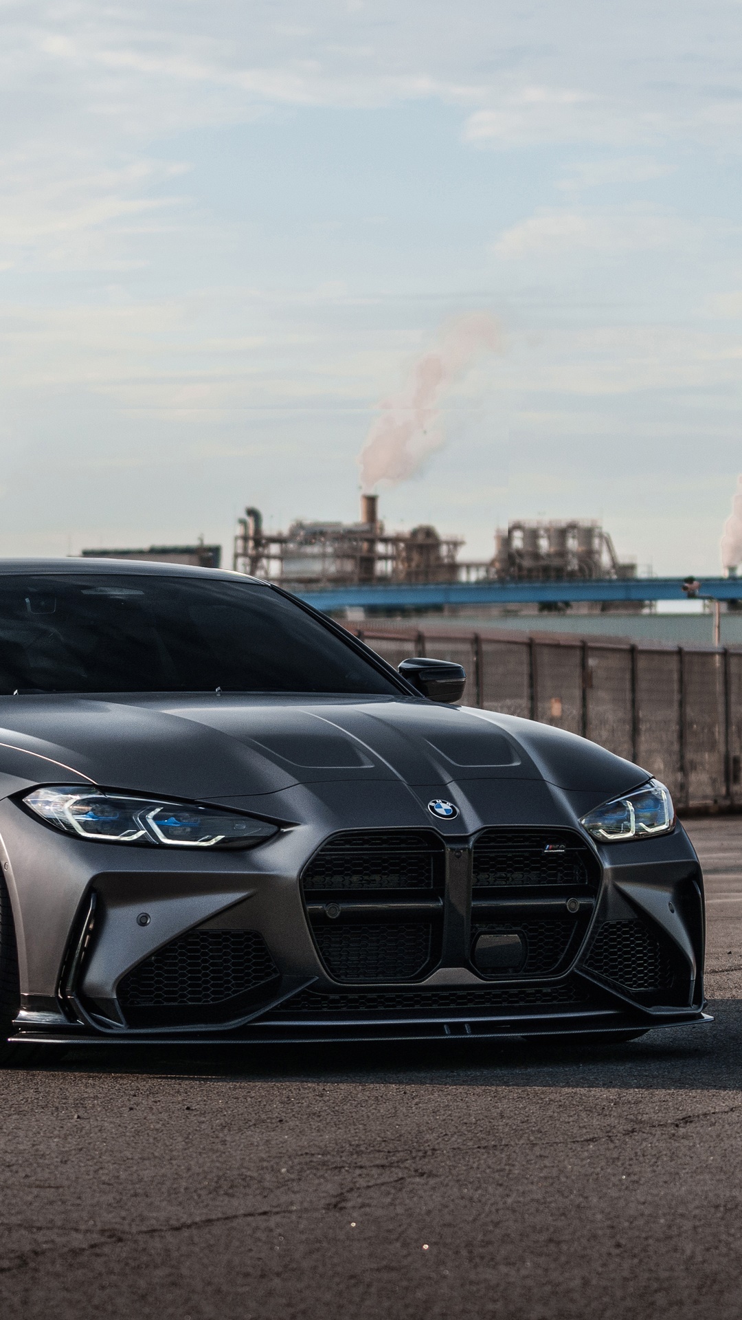 BMW M4 parked in front of industrial background HD Phone Wallpaper