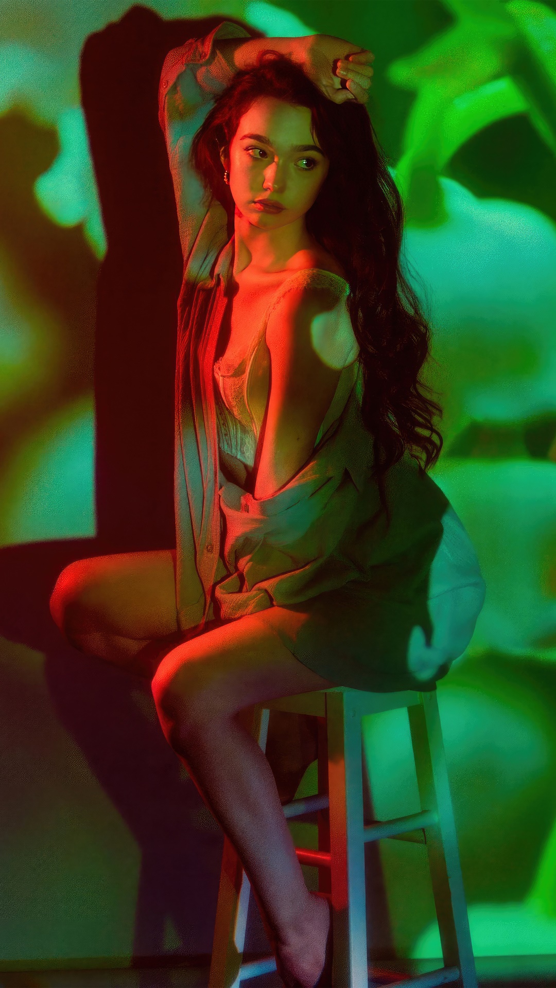 Ruby Jay posing in a studio with colored lights HD Phone Wallpaper