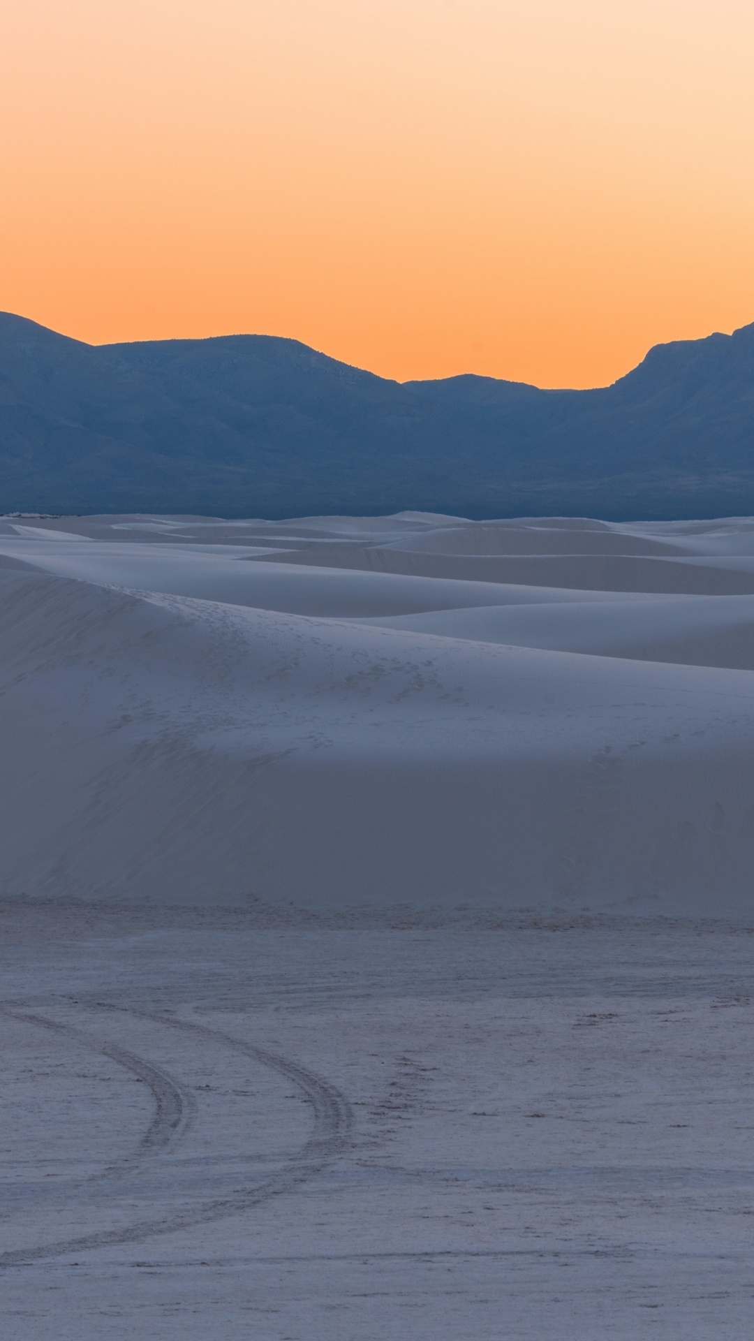 Sand dunes at sunset with mountains in the background HD Phone Wallpaper
