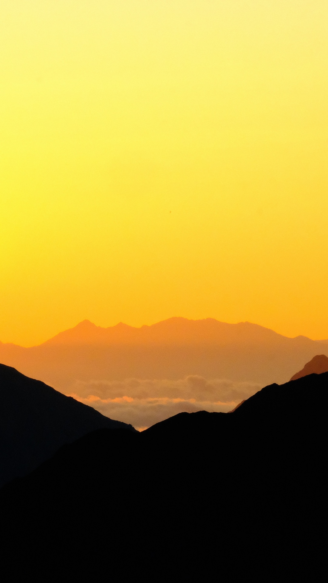Silhouette of mountains against a yellow sky HD Phone Wallpaper
