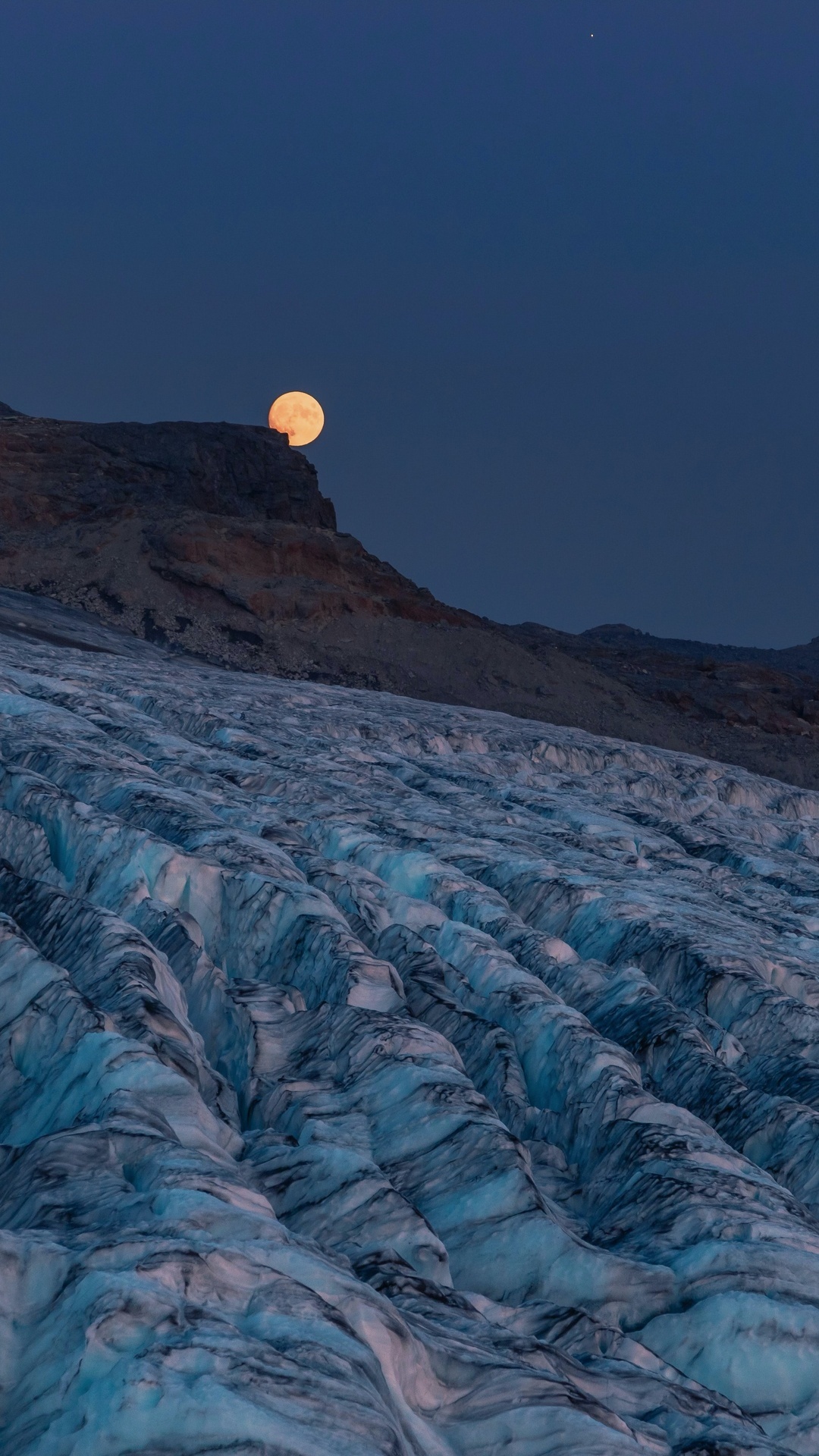 Moon setting over a glacier in the mountains HD Phone Wallpaper