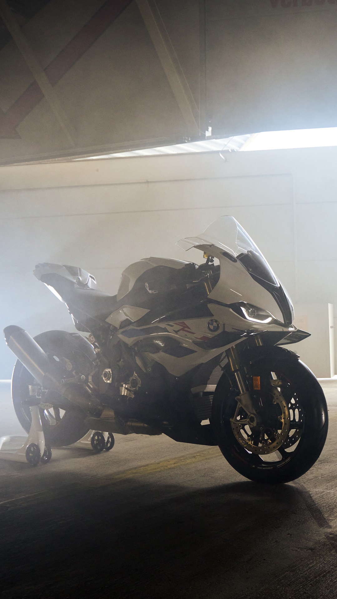 BMW S 1000 RR motorcycle in a smoky garage HD Phone Wallpaper