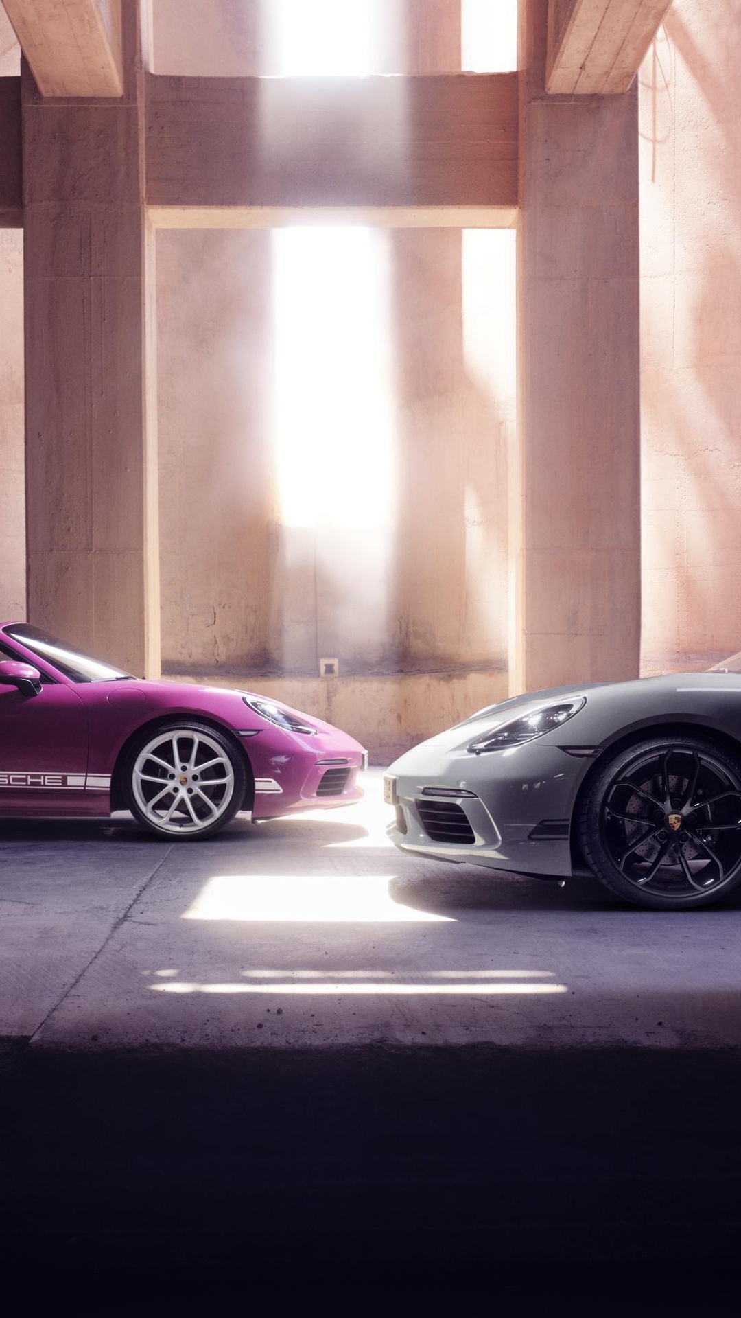 Two Porsche cars parked in a sunlit architectural space HD Phone Wallpaper