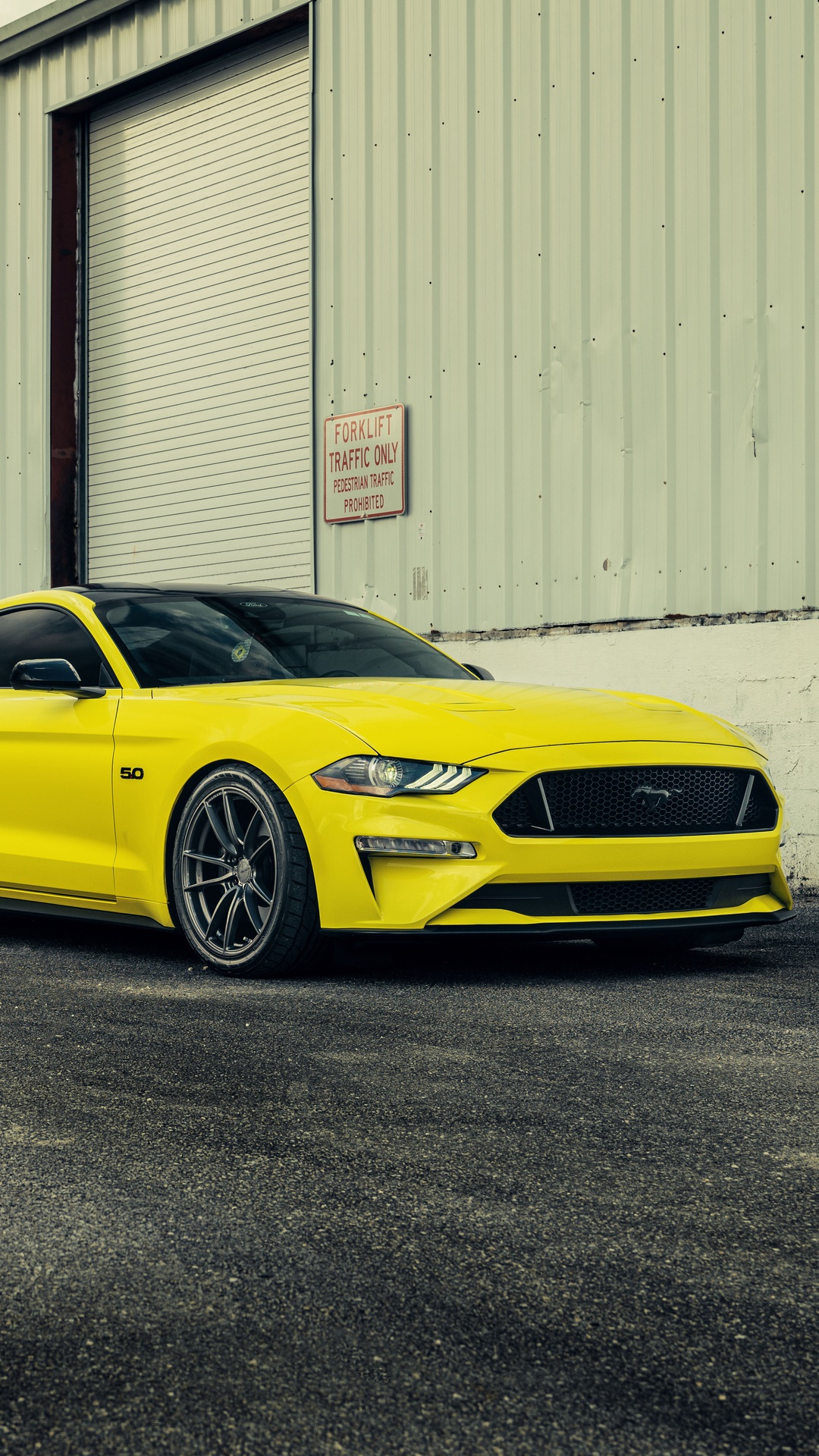 Yellow Ford Mustang 5.0 parked outside a building HD Phone Wallpaper