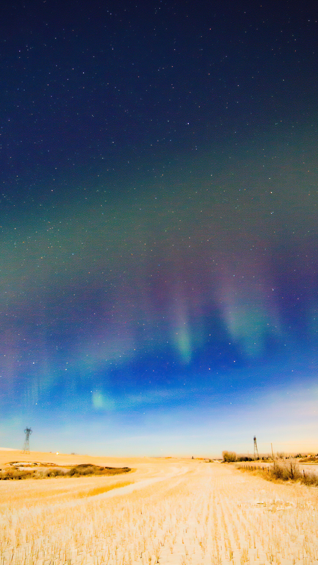 Aurora Borealis over a snowy field at night HD Phone Wallpaper