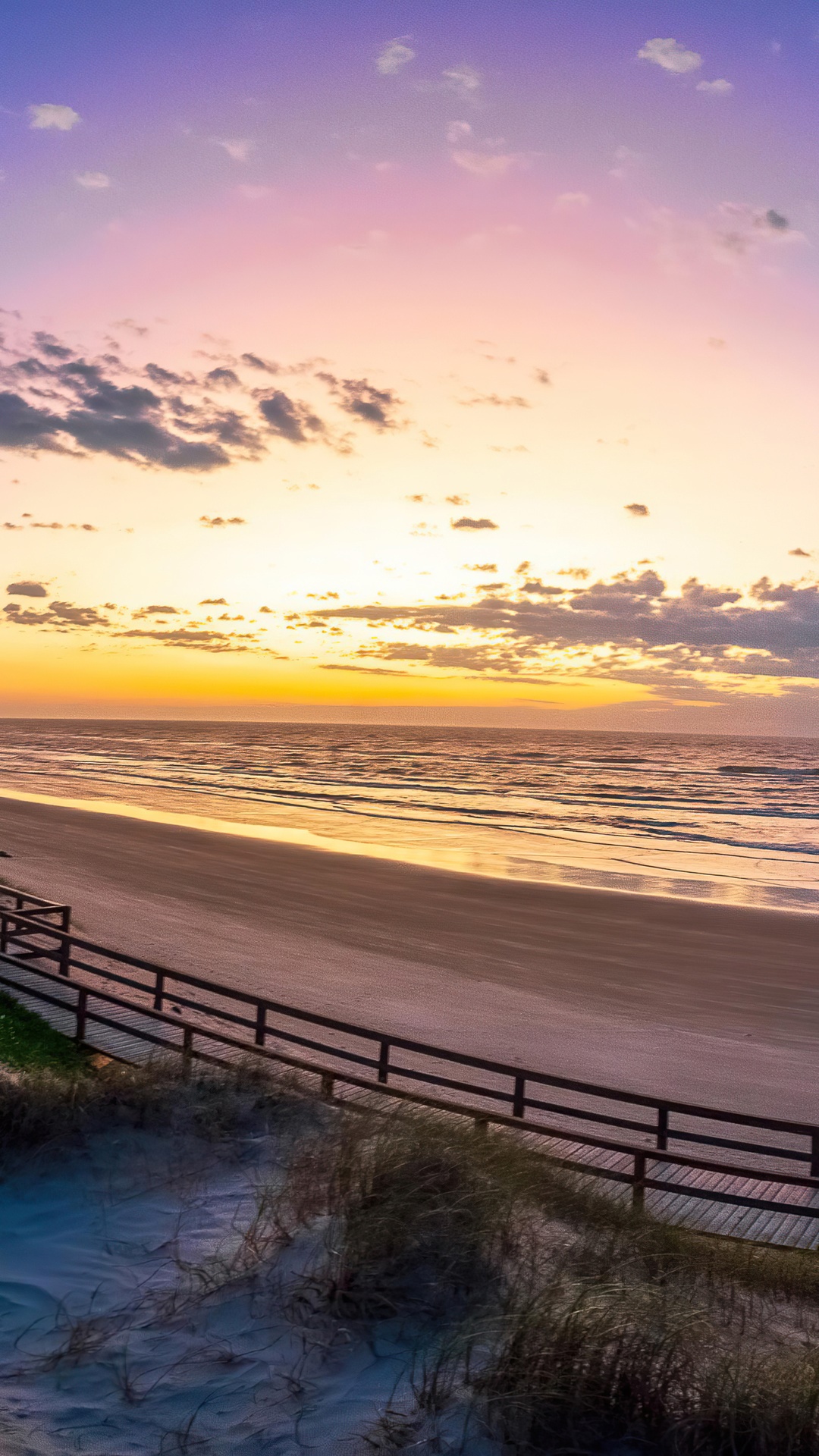 Sunset over a beach with a wooden boardwalk HD Phone Wallpaper