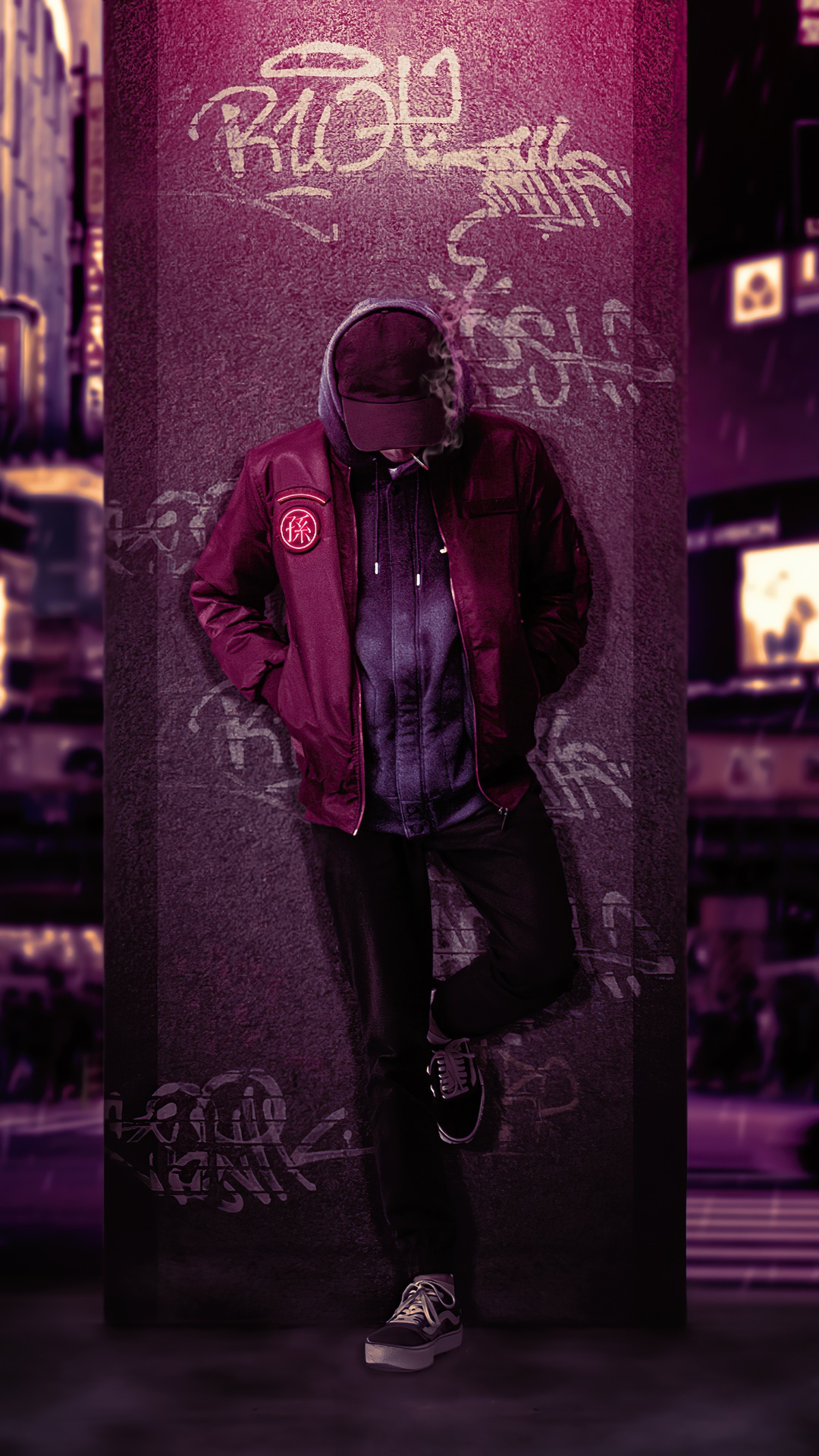 Man leaning against graffiti-covered pillar in city HD Phone Wallpaper