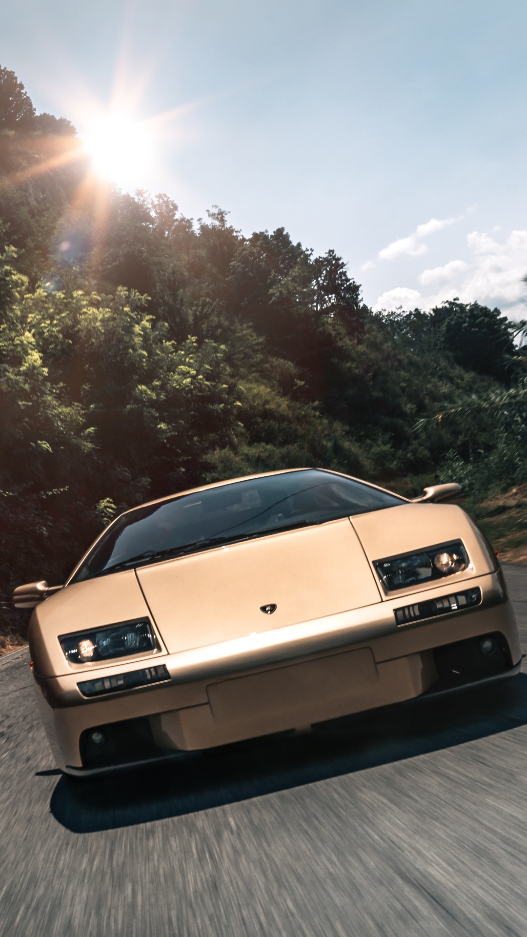 Gold Lamborghini Diablo driving on a road HD Phone Wallpaper