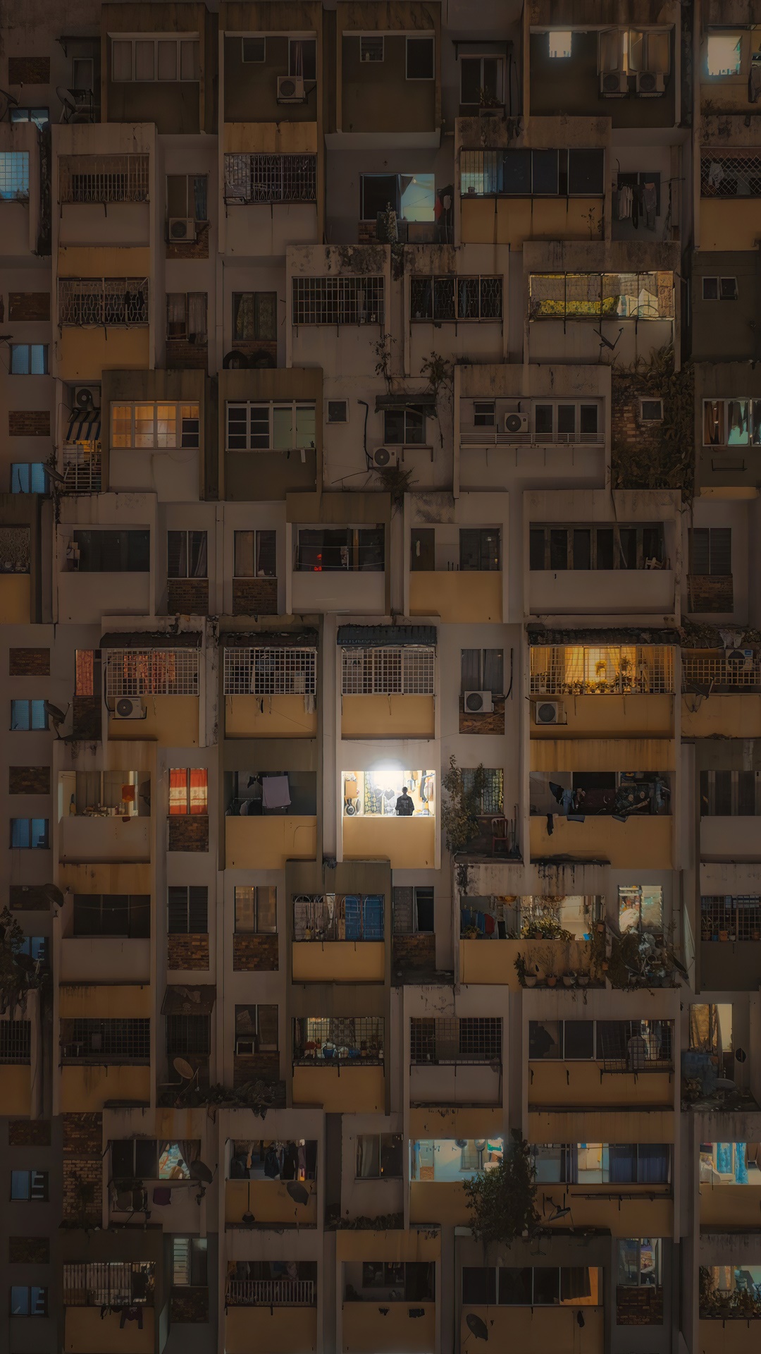 Apartment building at night with illuminated windows HD Phone Wallpaper