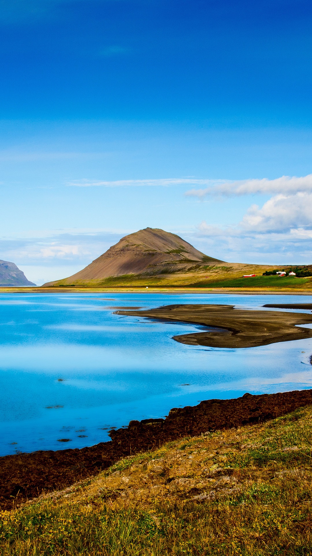 Icelandic landscape with a conical mountain and blue water HD Phone Wallpaper