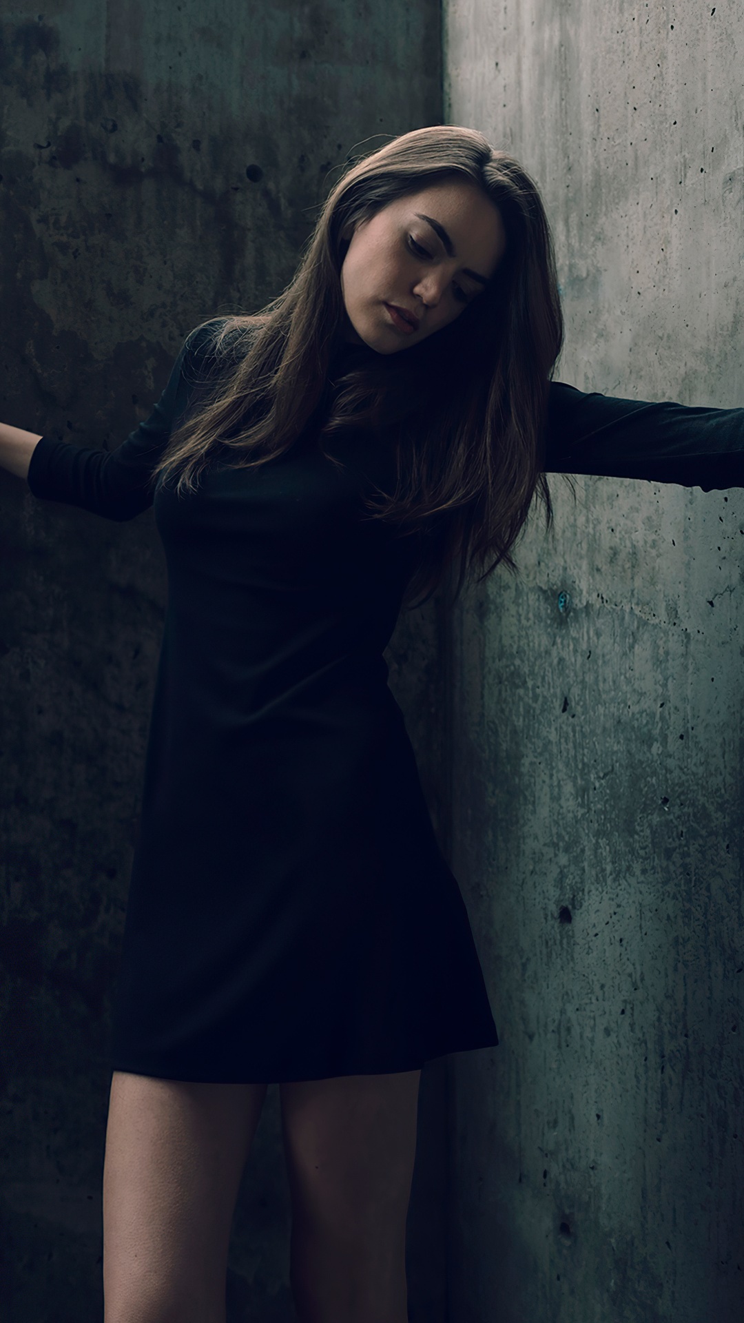 Girl in a black dress against a concrete wall HD Phone Wallpaper