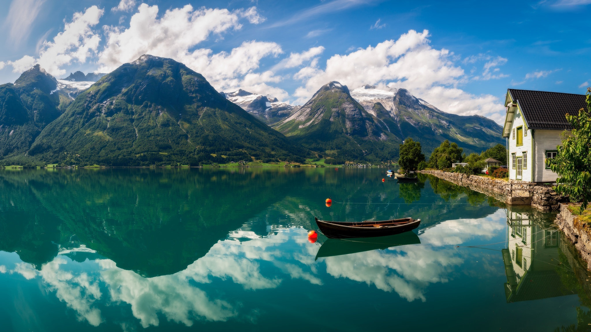 Boat on a lake with mountains and a house HD Wallpaper