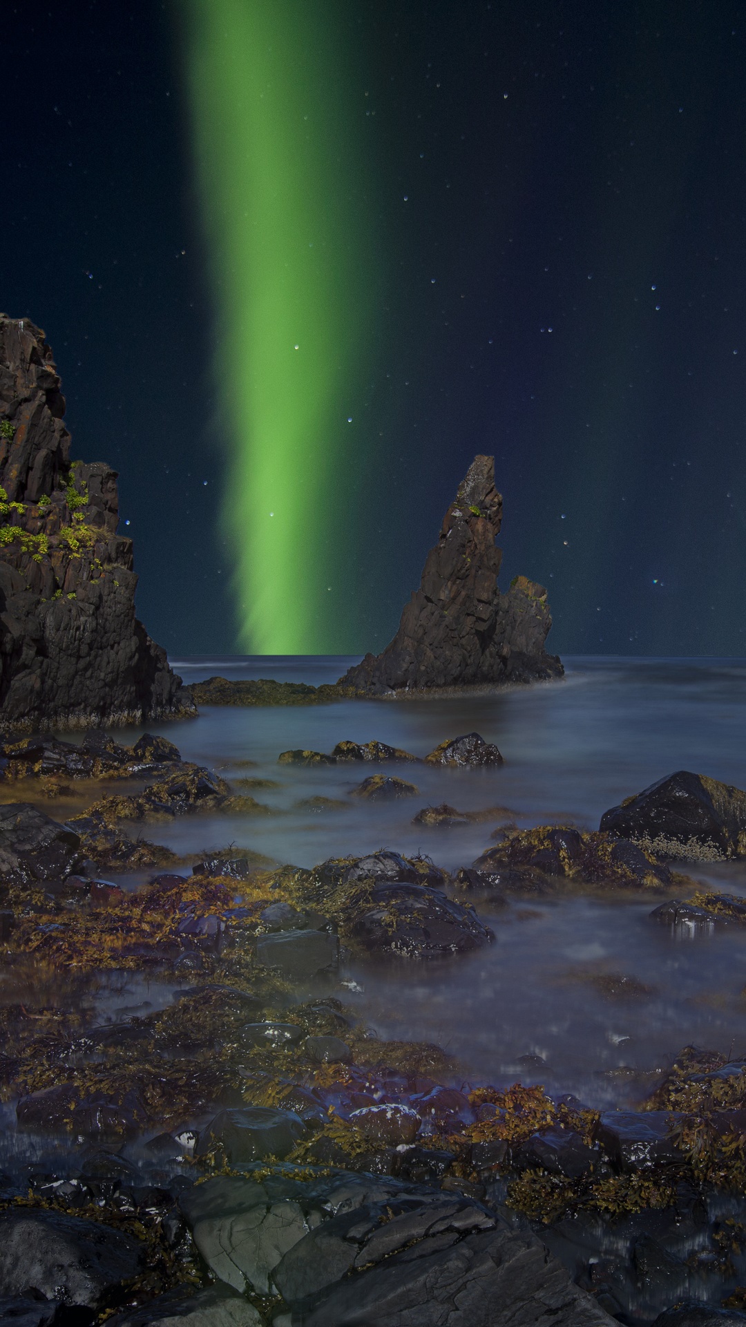 Aurora Borealis over rocky coast in Iceland HD Phone Wallpaper