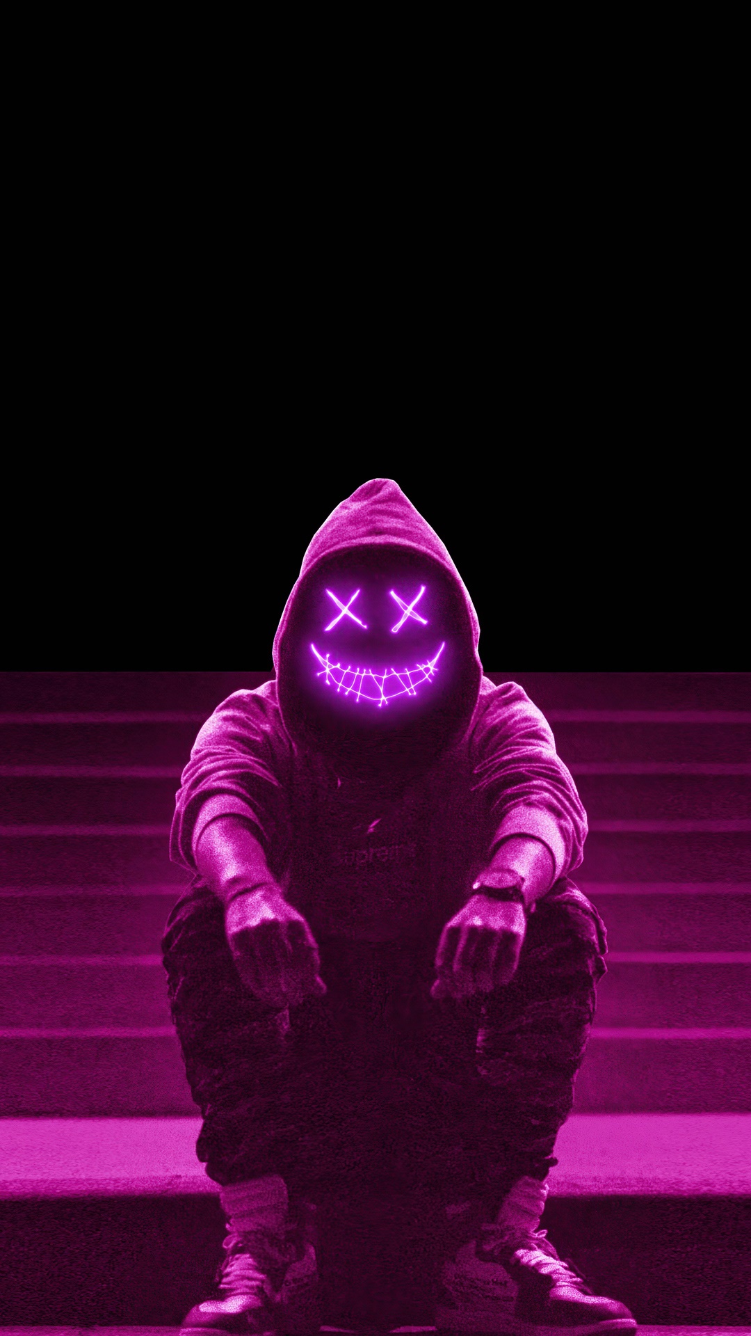 Person in a neon mask and hoodie sitting on stairs HD Phone Wallpaper