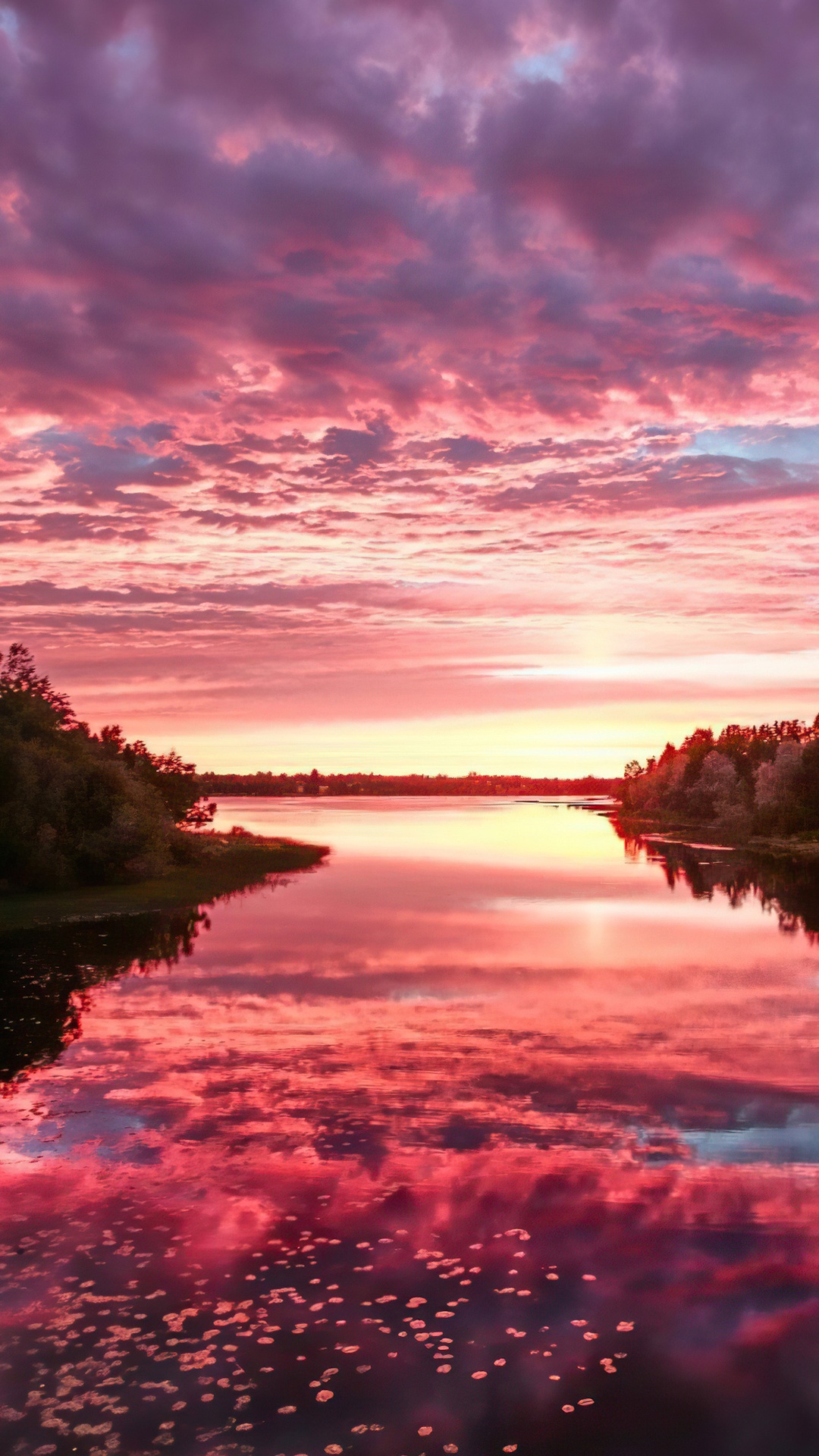 Pink and purple clouds over a lake at sunset HD Phone Wallpaper