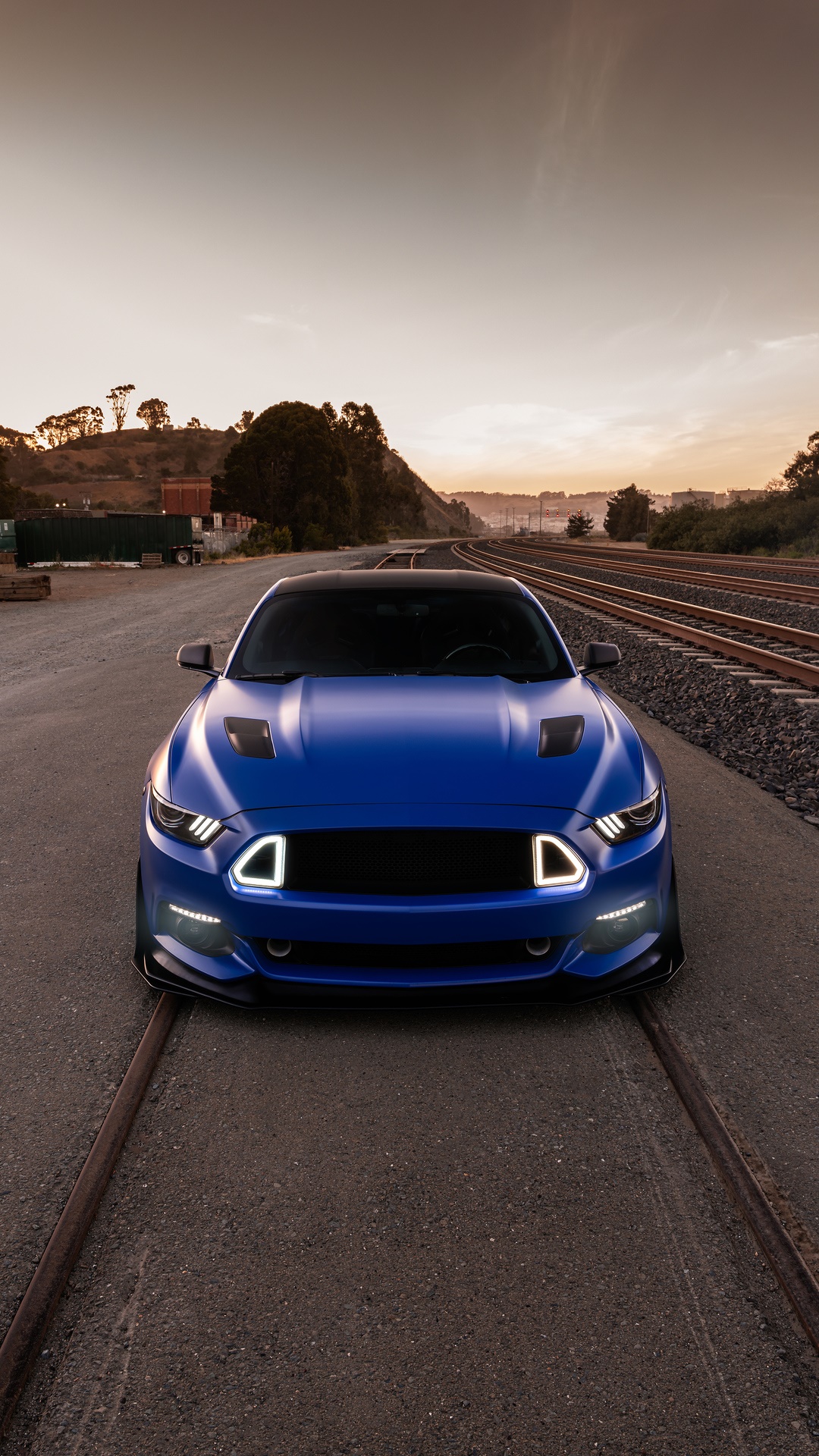 Blue Ford Mustang on Train Tracks at Sunset HD Phone Wallpaper
