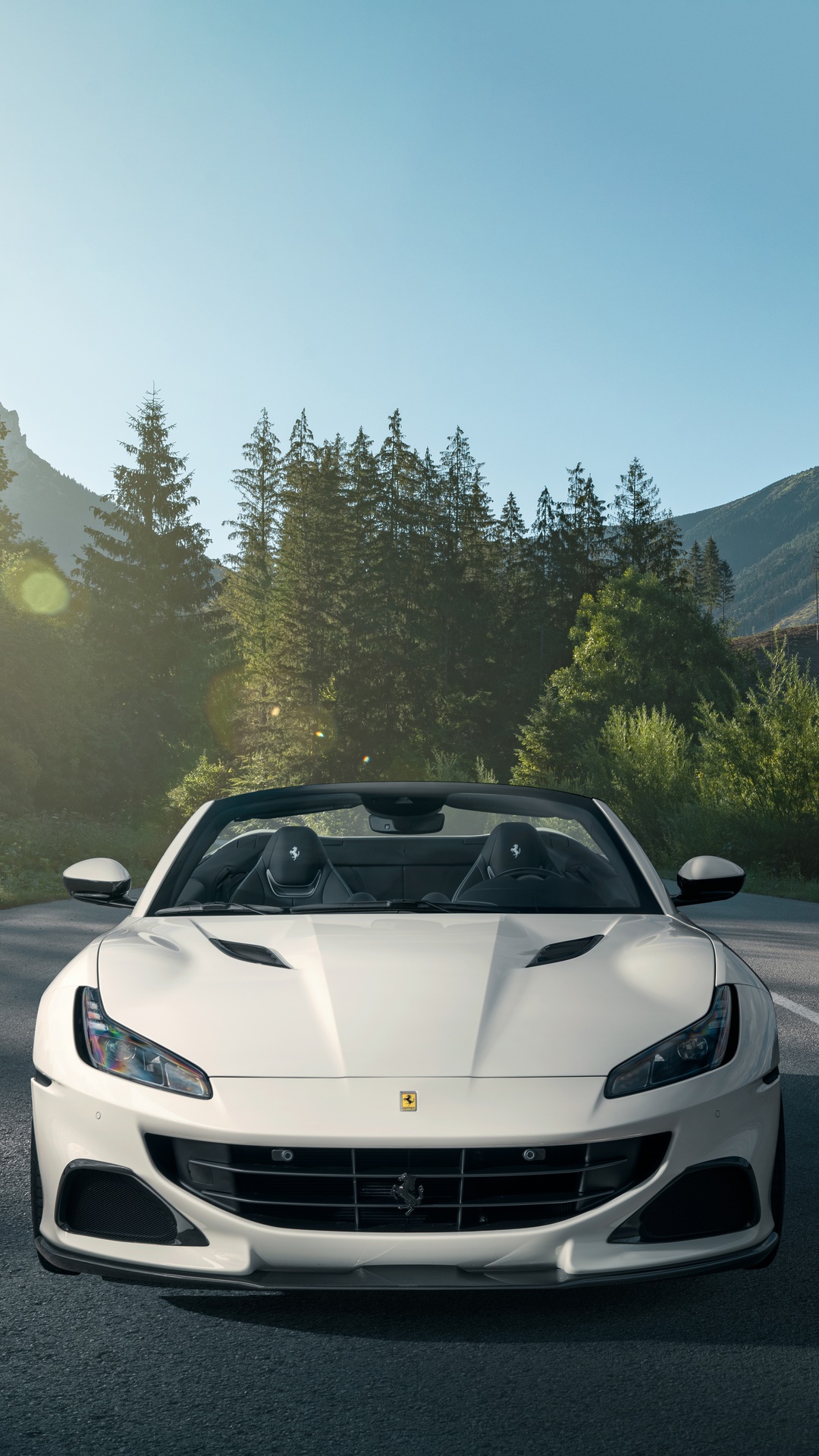 White Ferrari Portofino convertible driving on a mountain road HD Phone Wallpaper