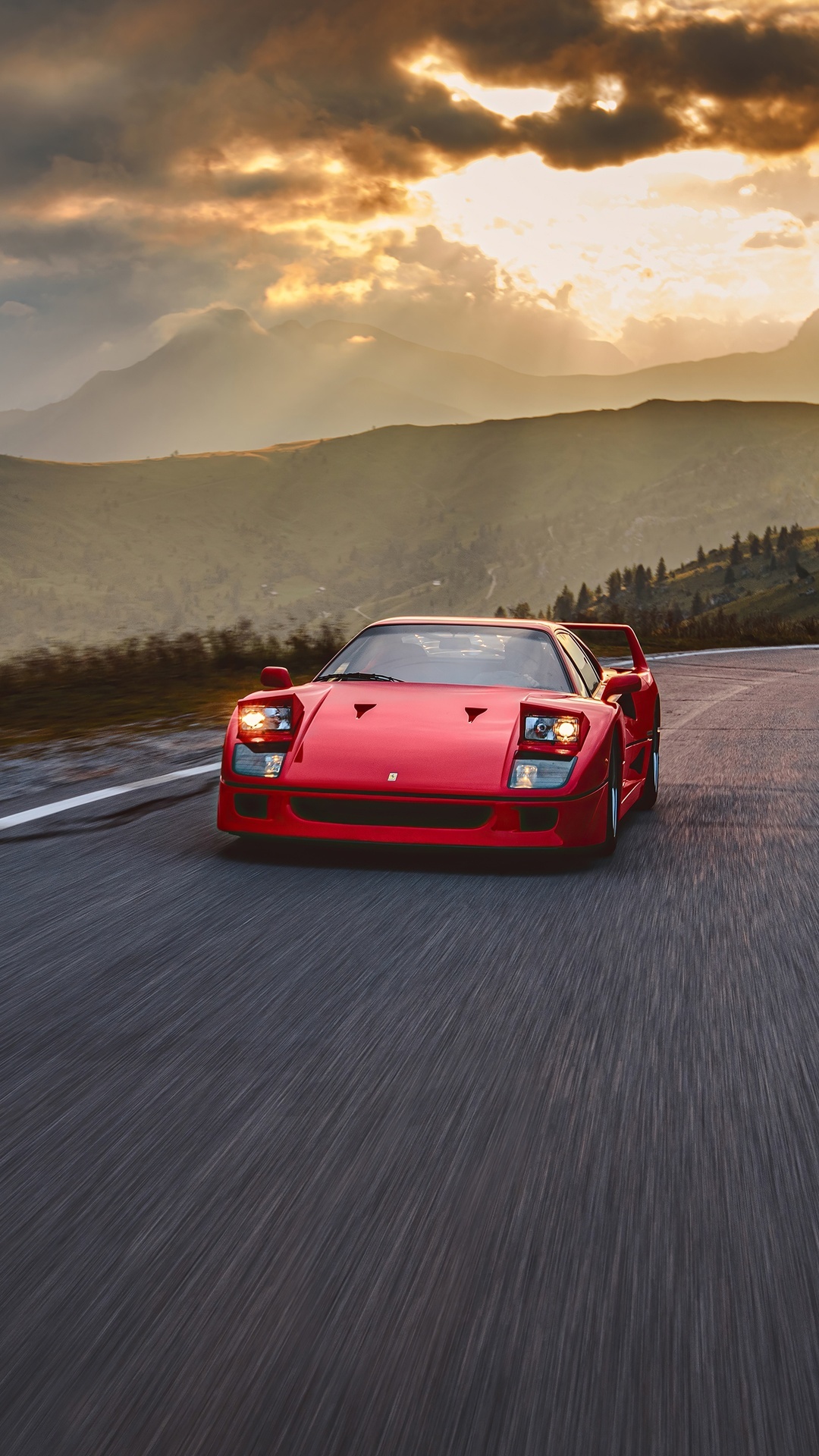Red Ferrari F40 driving on a mountain road HD Phone Wallpaper