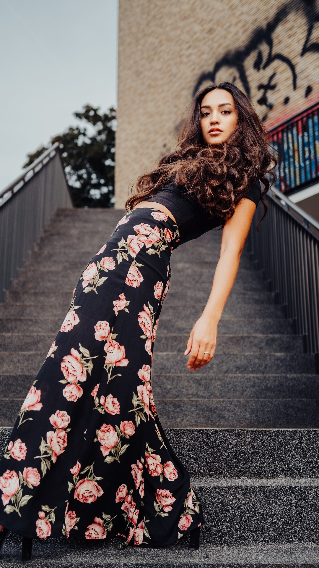 Young woman in a floral skirt on stairs HD Phone Wallpaper