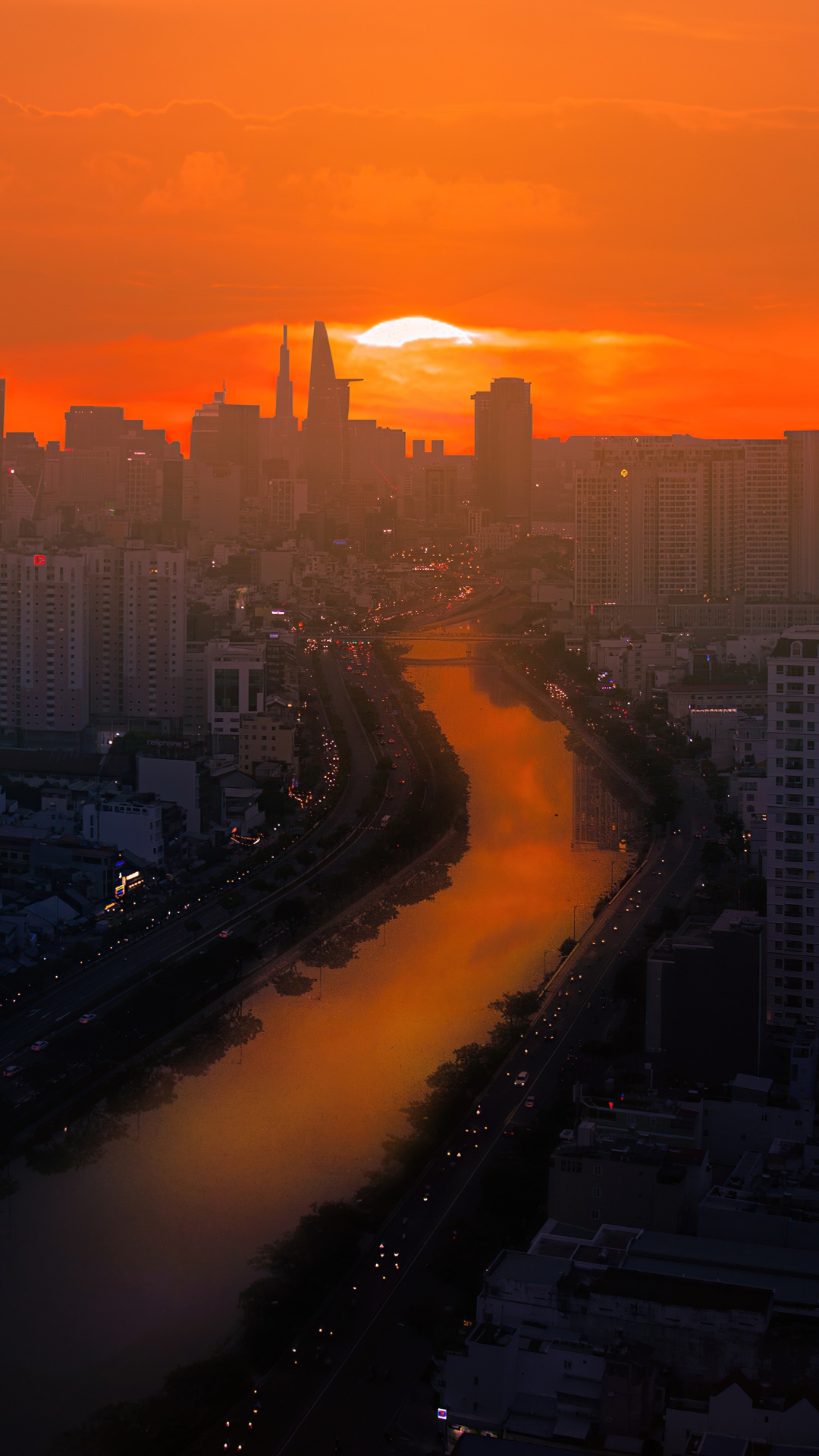 Cityscape at sunset with river and skyscrapers HD Phone Wallpaper