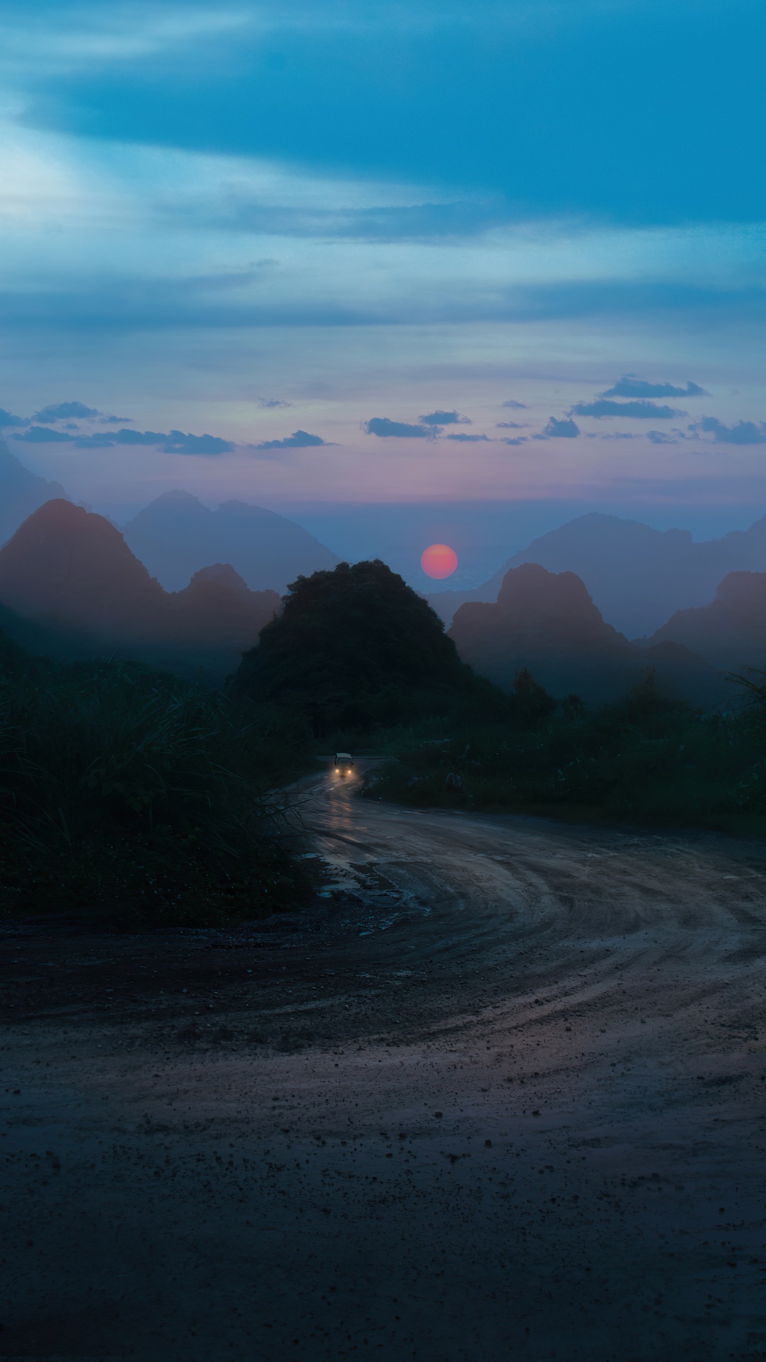 Digital art of a car on a mountain road at sunset HD Phone Wallpaper