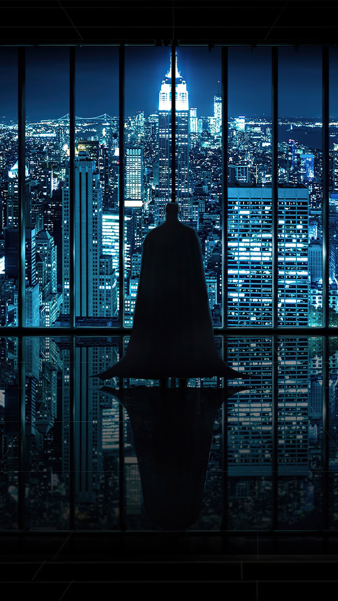 Batman standing in front of a city skyline at night HD Phone Wallpaper