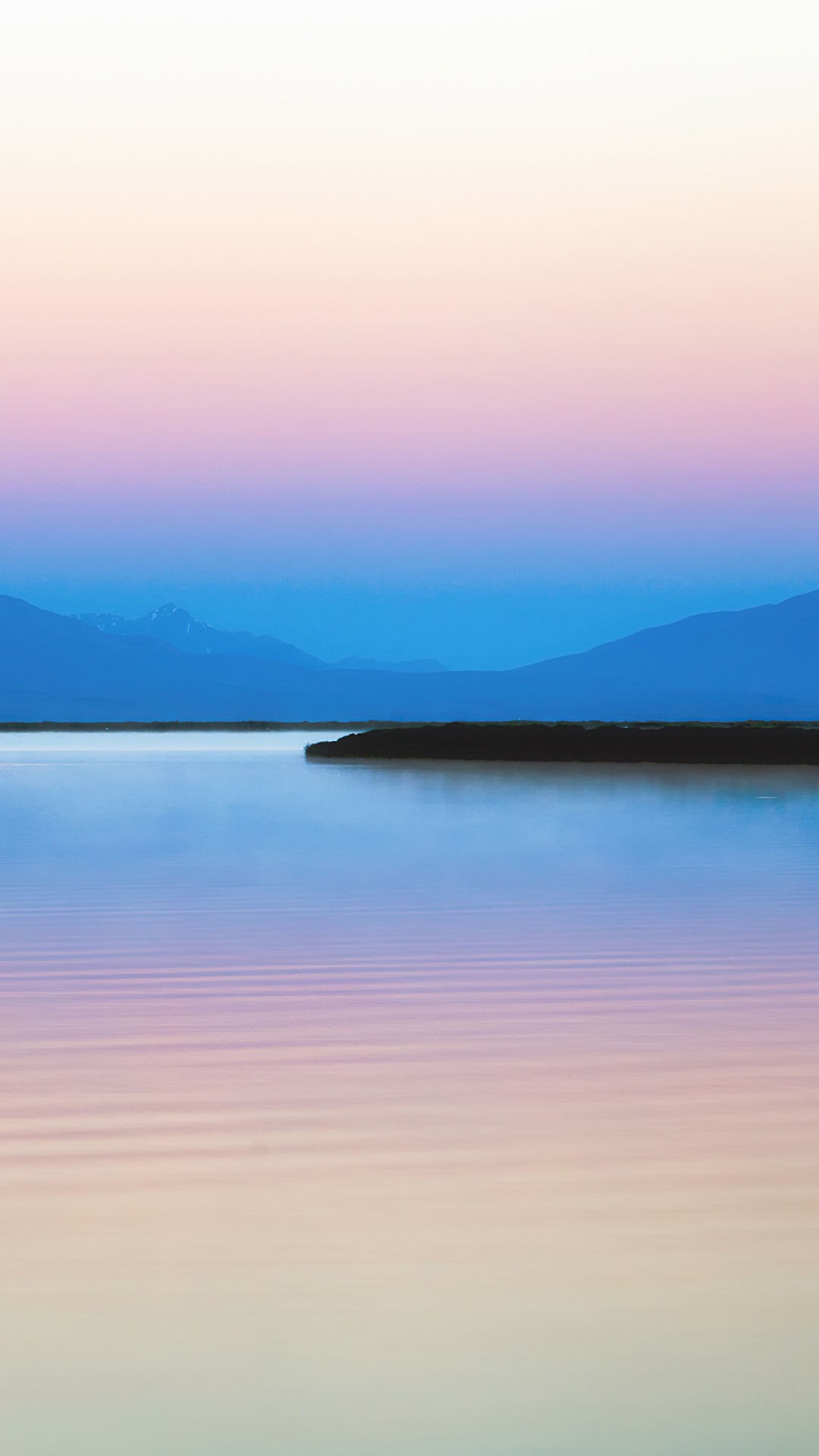 Mountains silhouette over a calm lake at sunset HD Phone Wallpaper