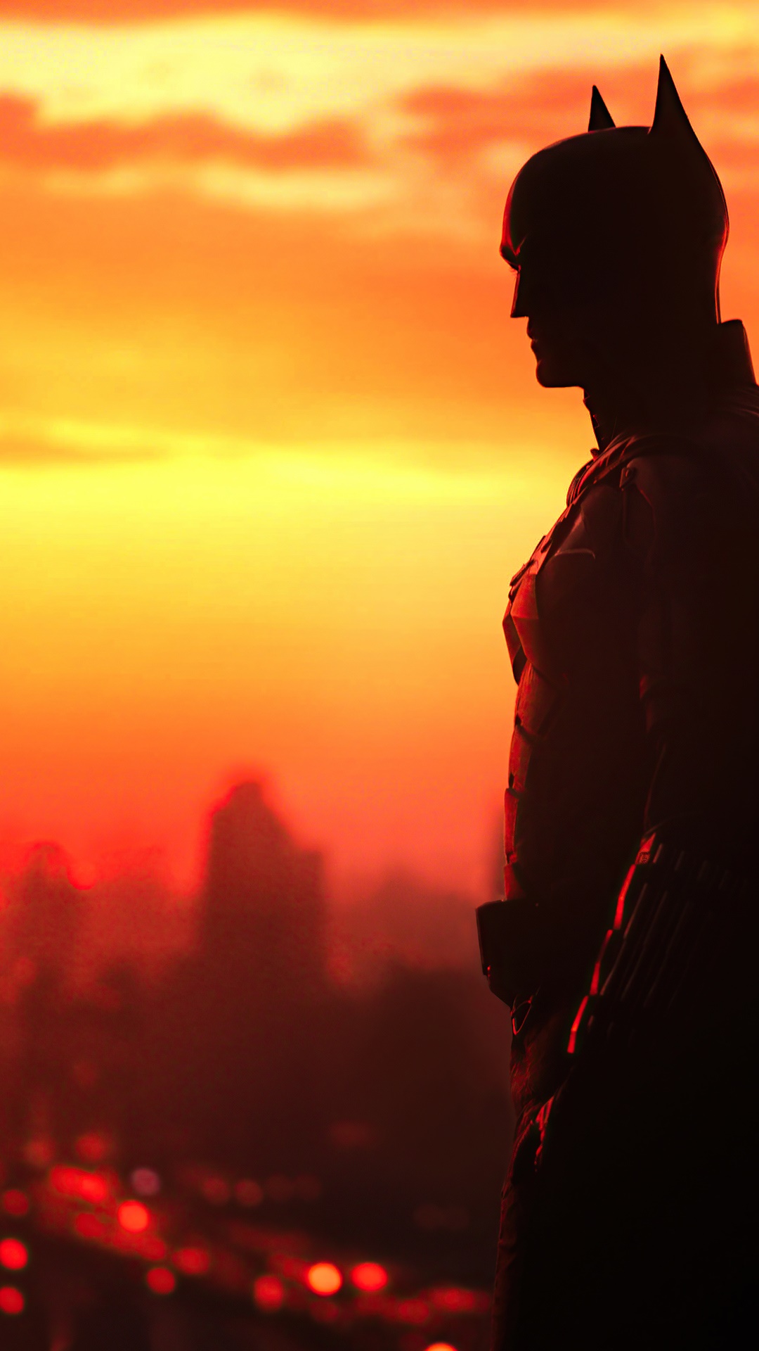 The Batman silhouetted against an orange sunset HD Phone Wallpaper