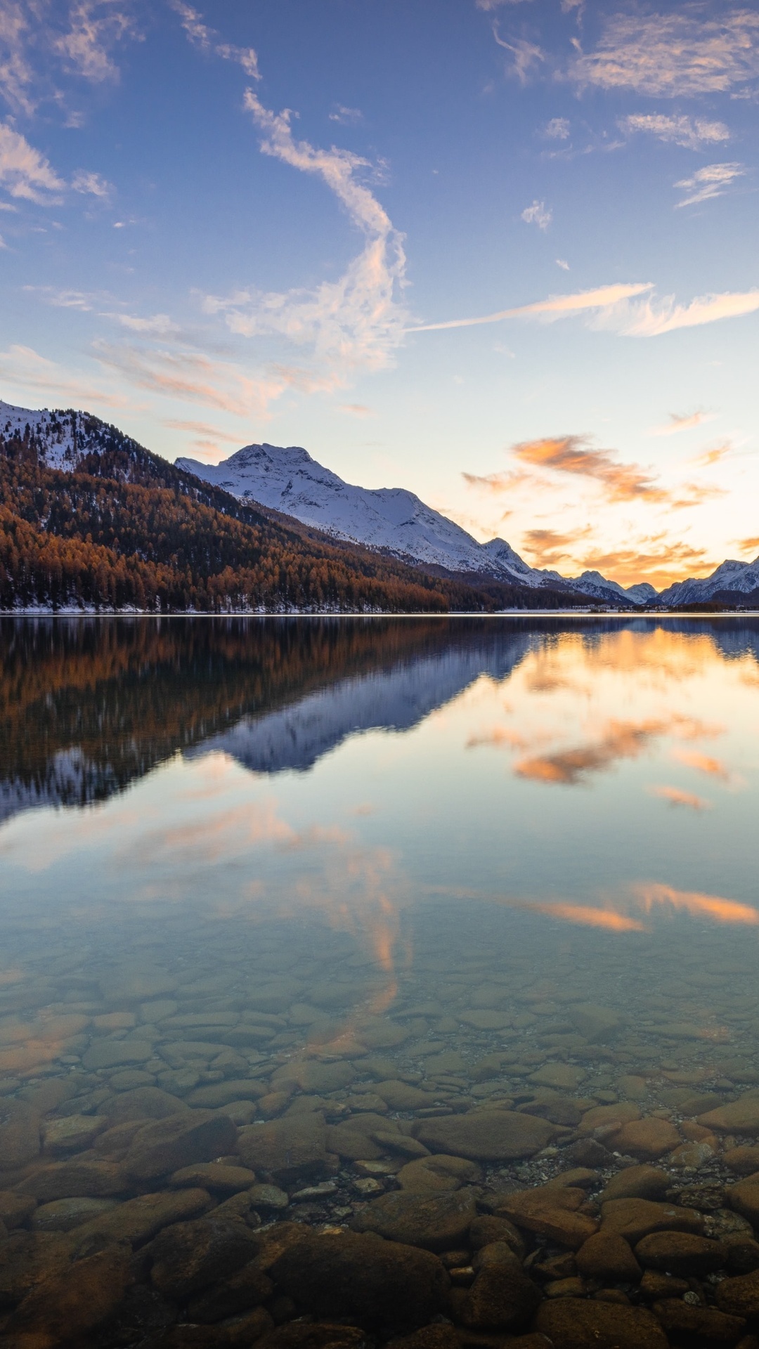 Mountains reflected in a calm lake at sunset HD Phone Wallpaper