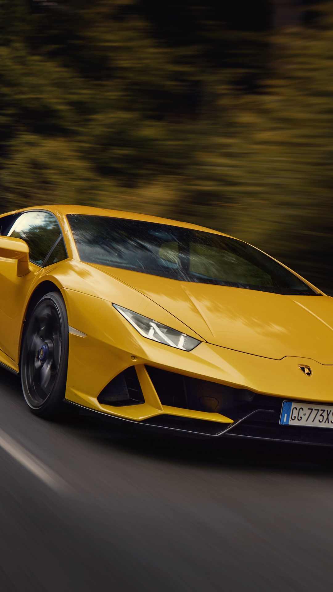 Yellow Lamborghini Huracan Evo driving on road HD Phone Wallpaper