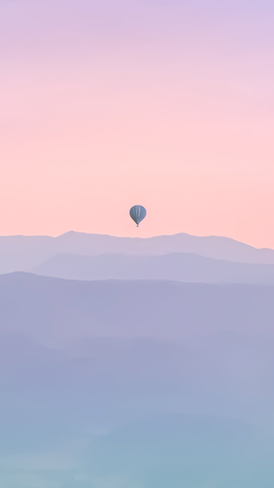 Hot air balloon over misty mountains at sunrise HD Phone Wallpaper