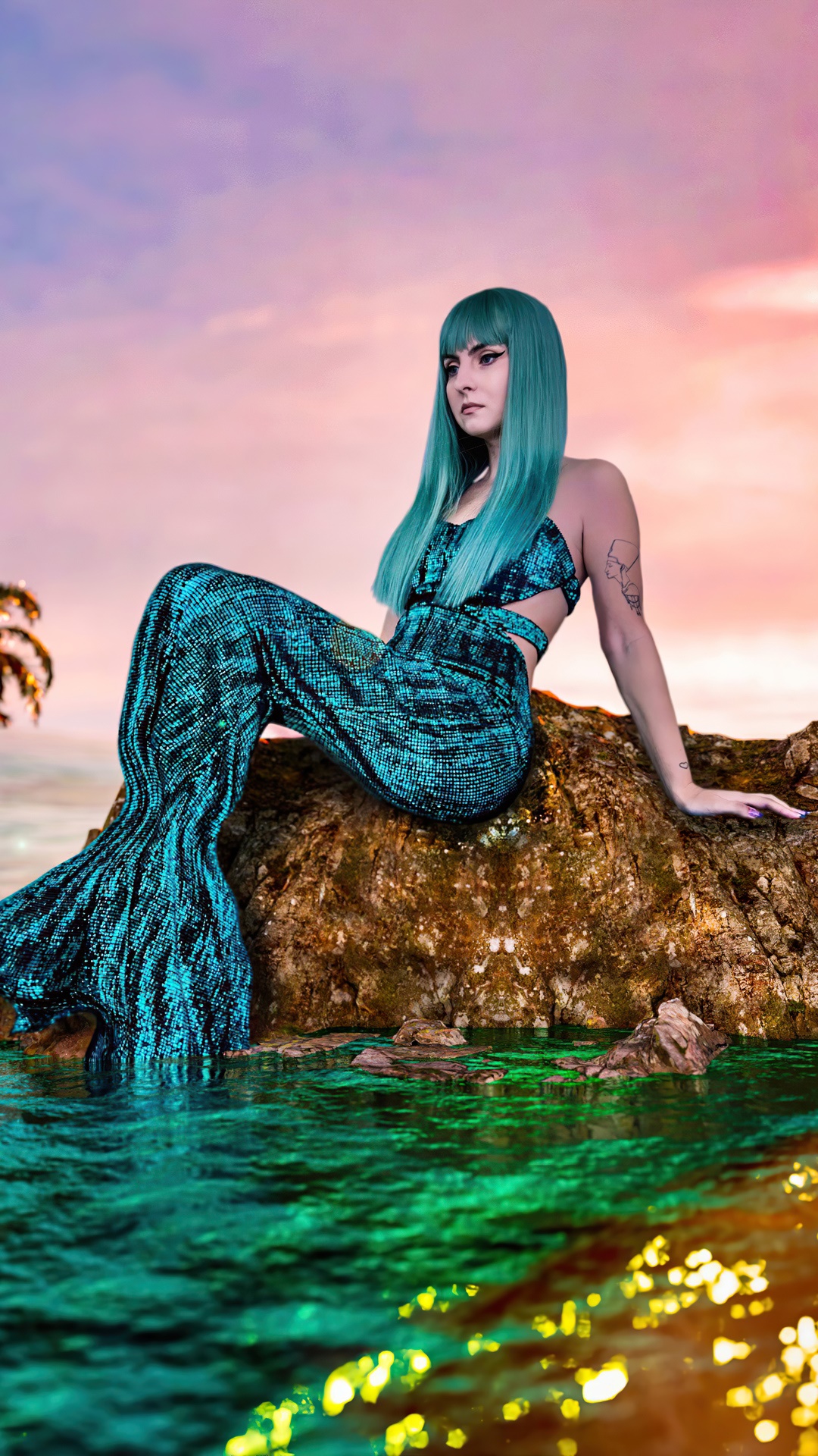 Mermaid cosplay sitting on a rock at sunset HD Phone Wallpaper
